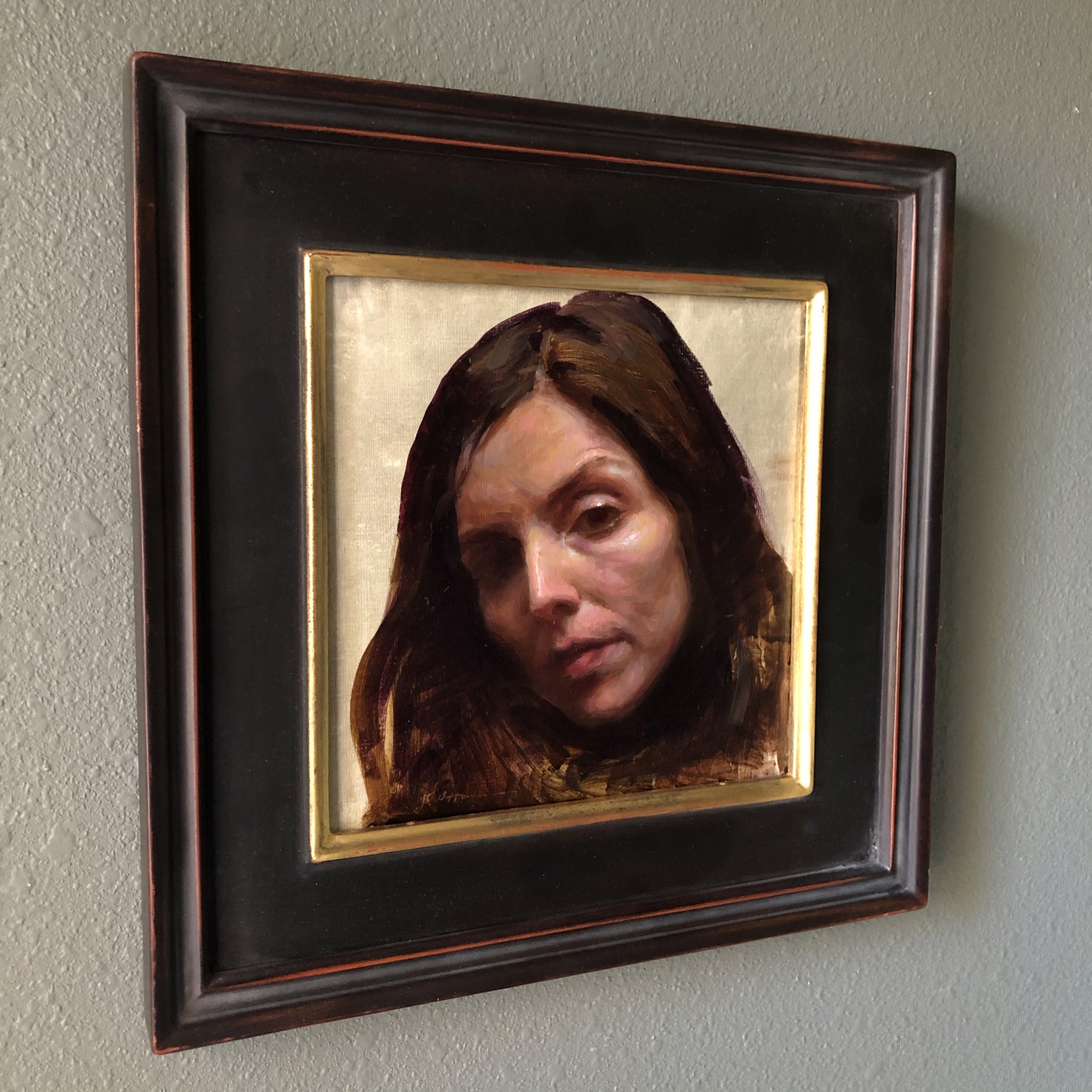 A painting of a woman with long brown hair.