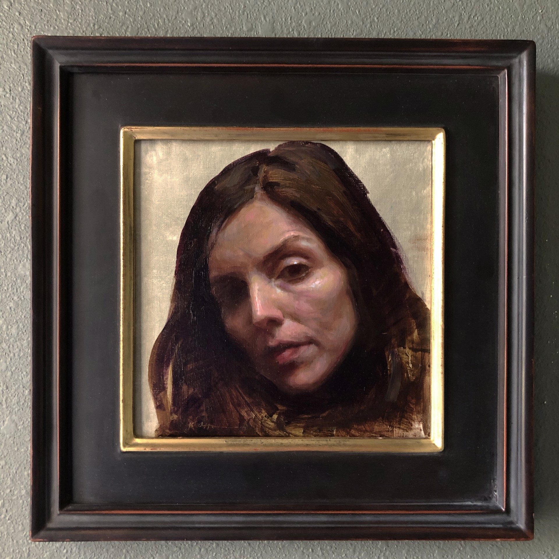 A painting of a woman with long brown hair.