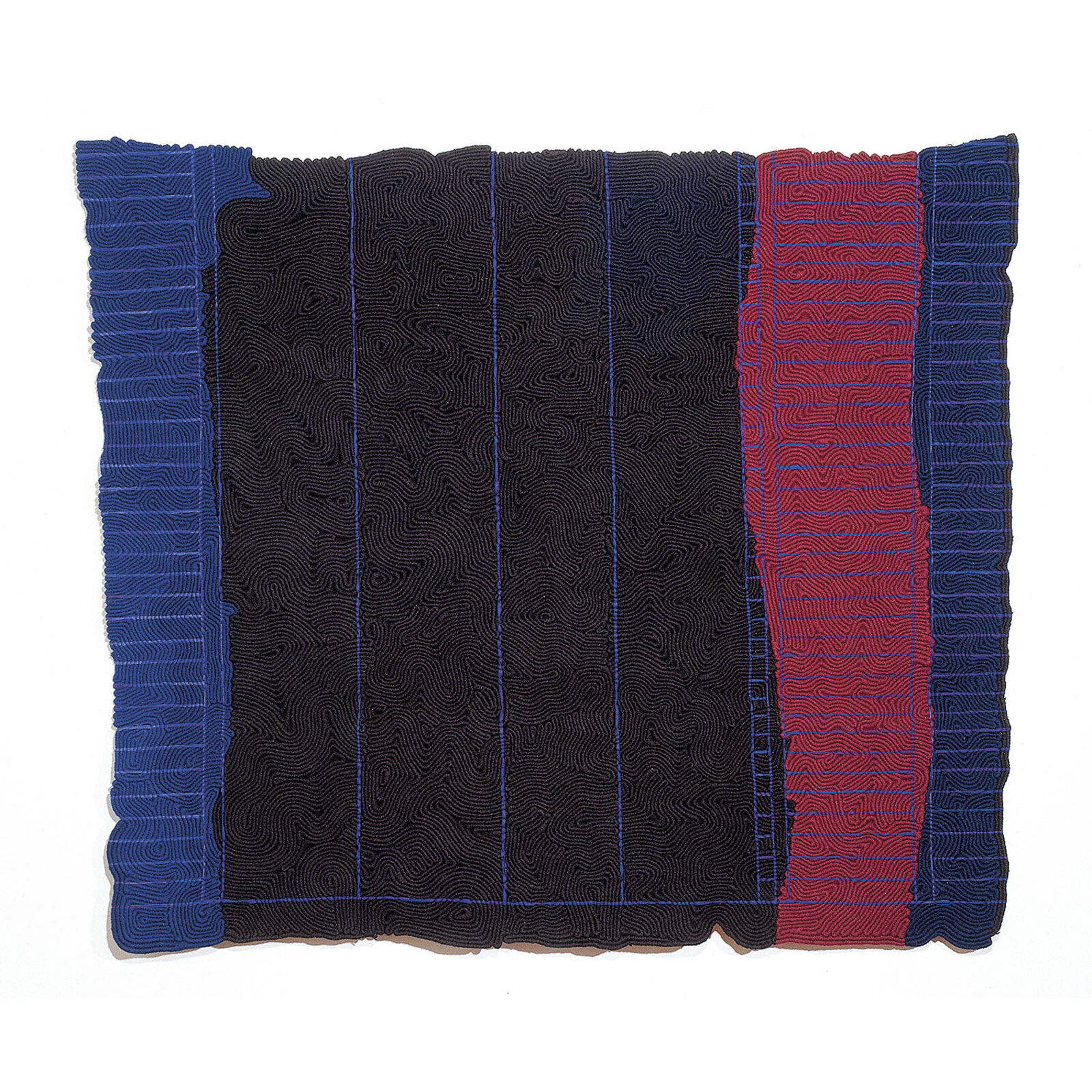 A black and blue blanket hanging on a wall in a room.