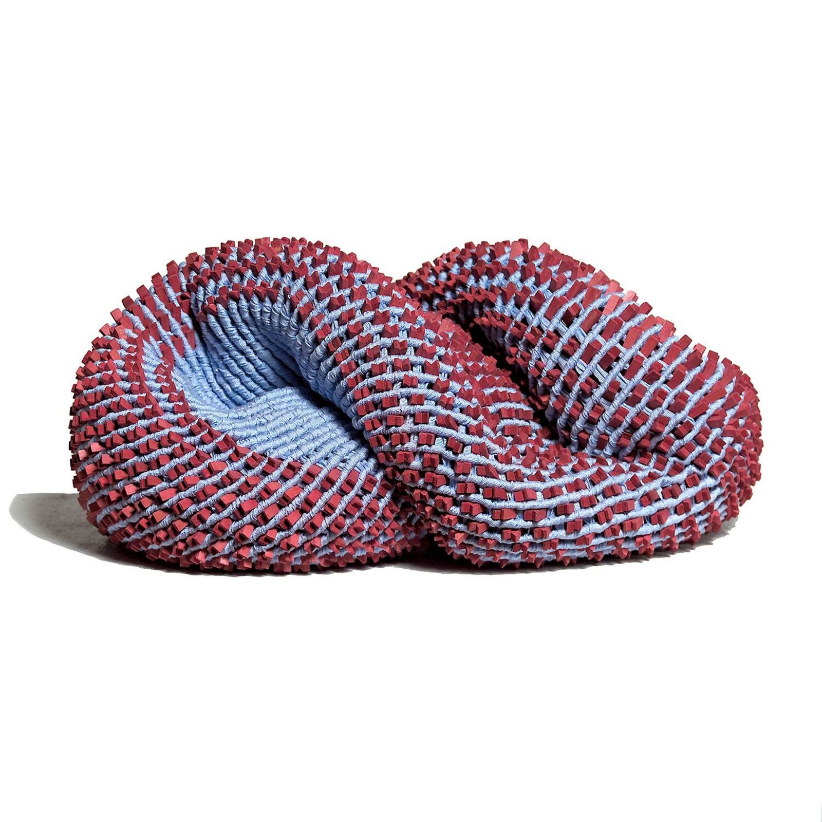 A red and blue knitted object on a white surface.
