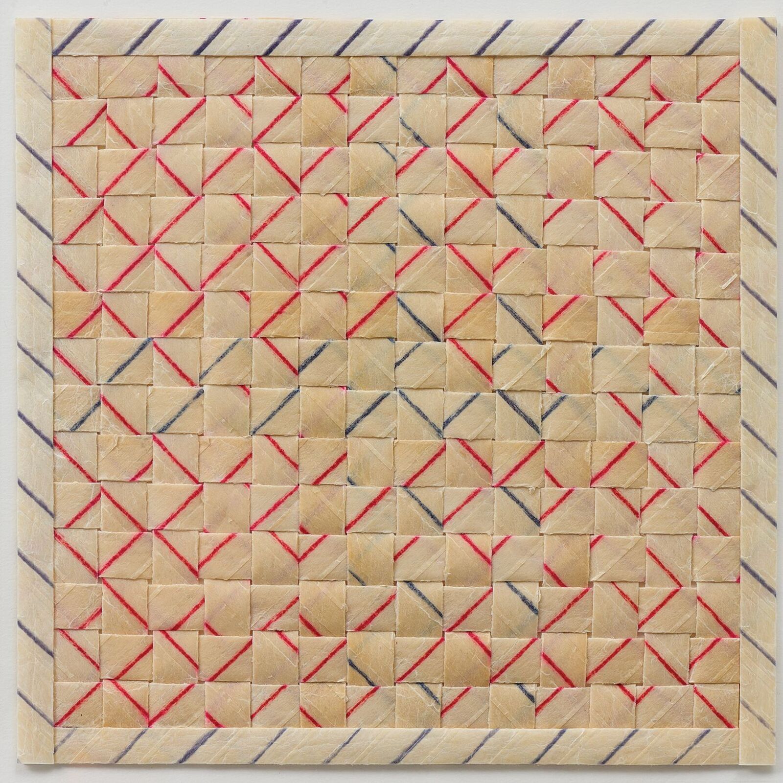 A framed textile artwork featuring a geometric grid pattern with red and black threads on a beige background.