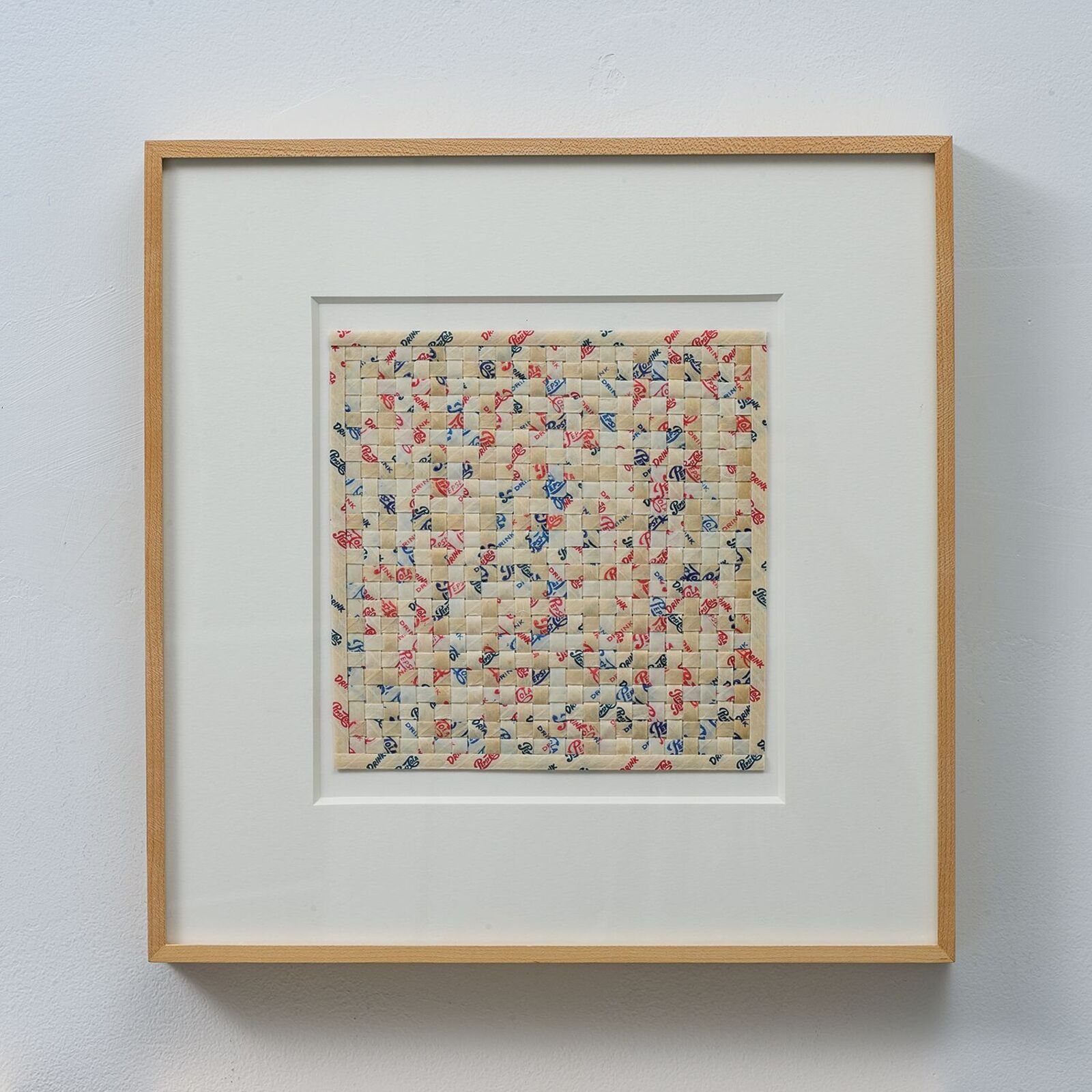 A framed textile artwork featuring a quilted floral pattern.