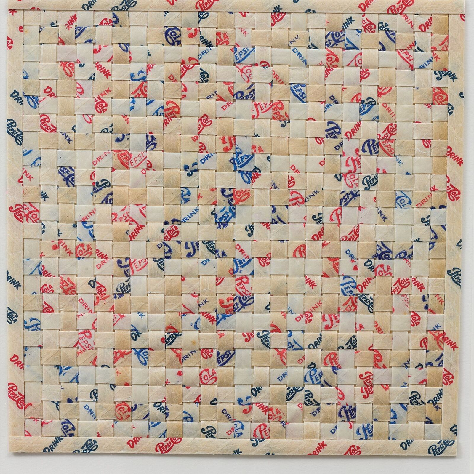 A framed textile artwork featuring a quilted floral pattern.
