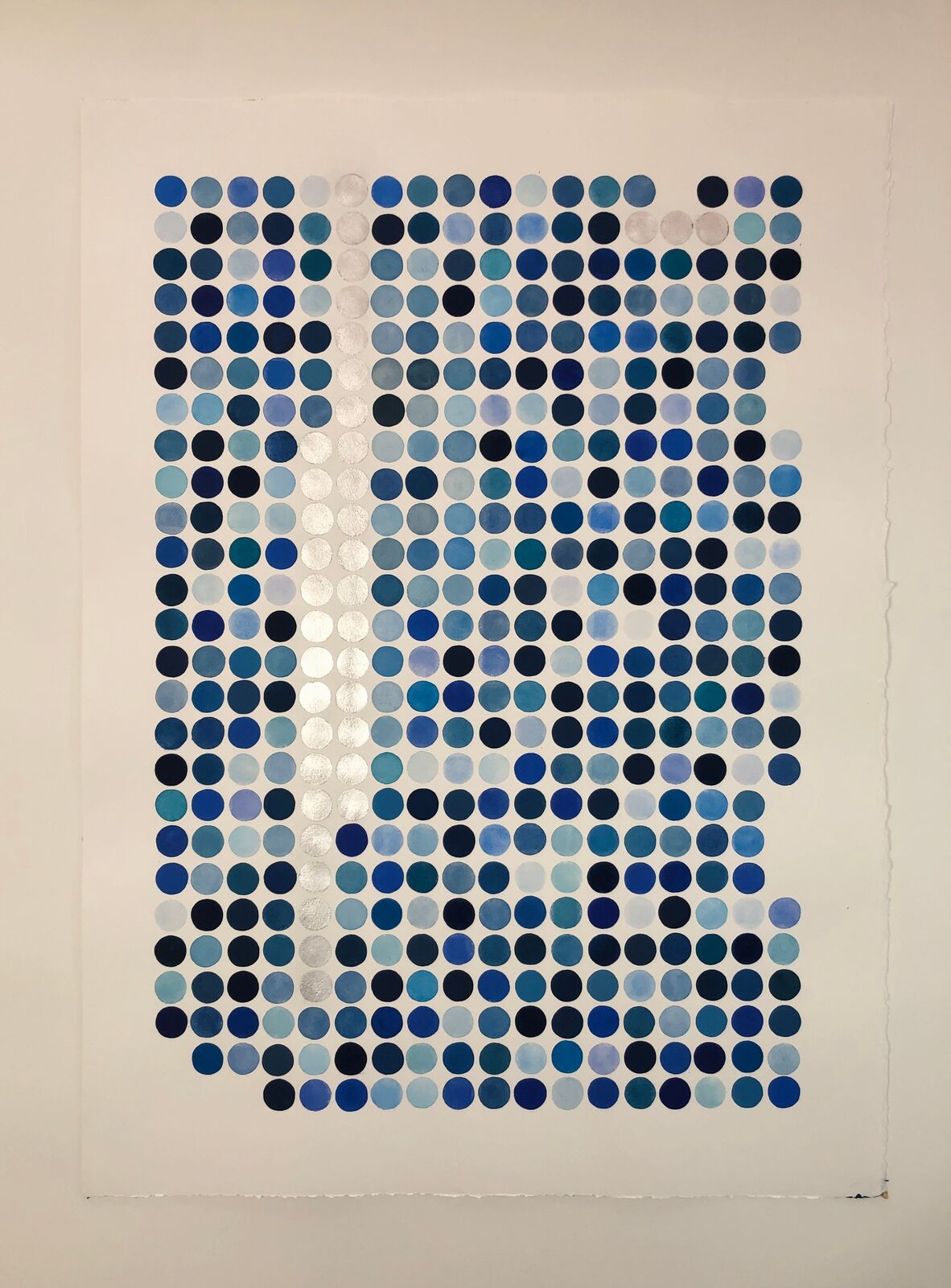 A portrait formed by a grid of blue and silver dots on white paper.