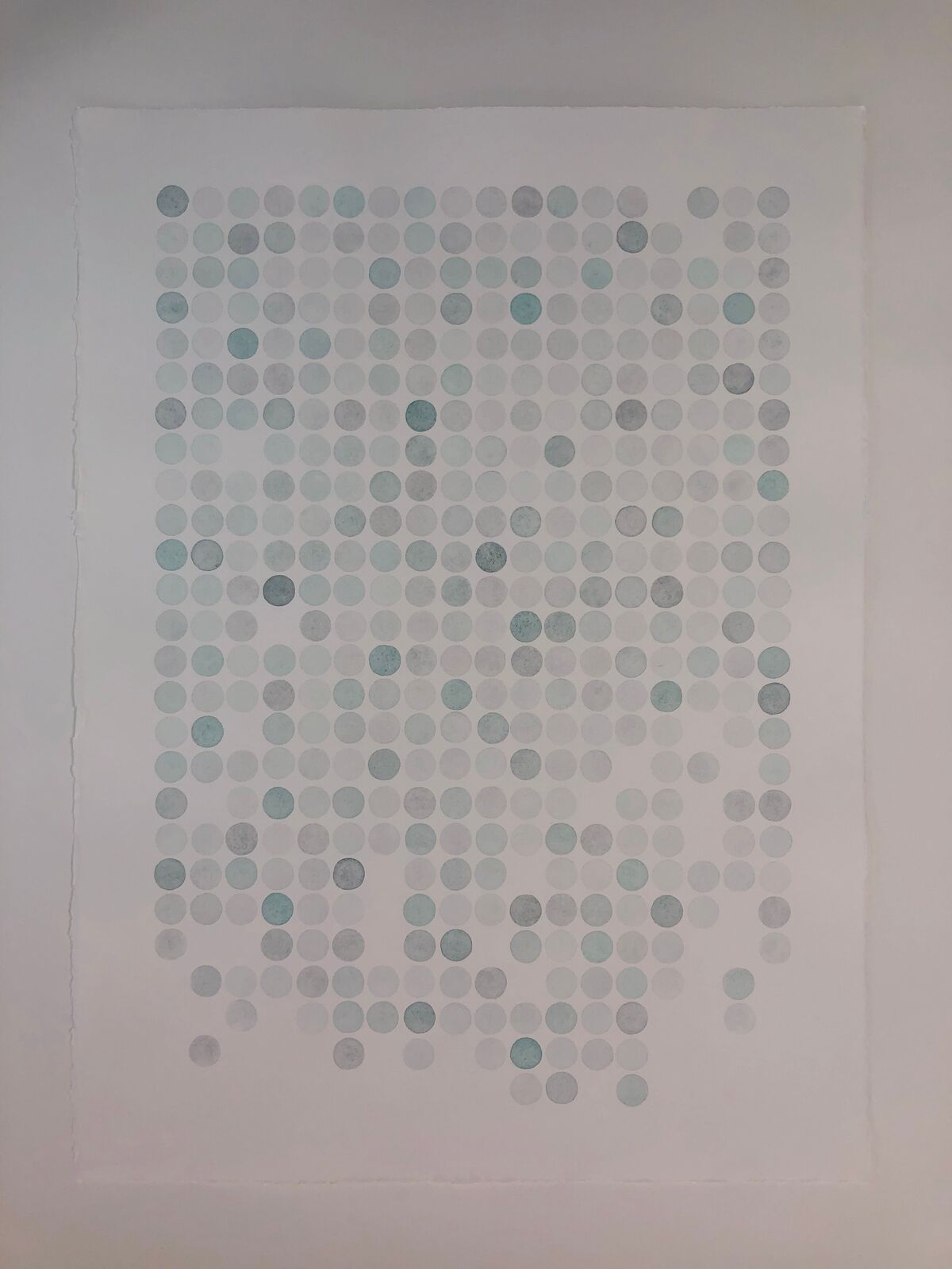 A minimalist portrait composed of a grid of muted blue and grey dots on white paper.