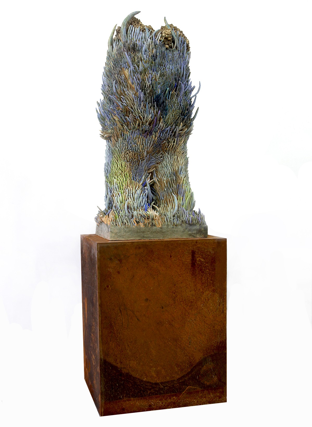 A sculpture of a bird sitting on top of a metal pedestal in the grass.