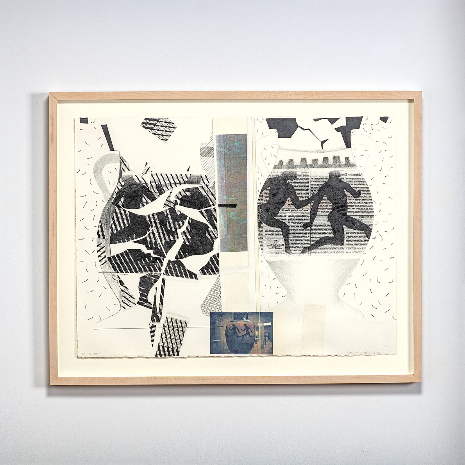 A black and white collage hanging on a wall in a room.