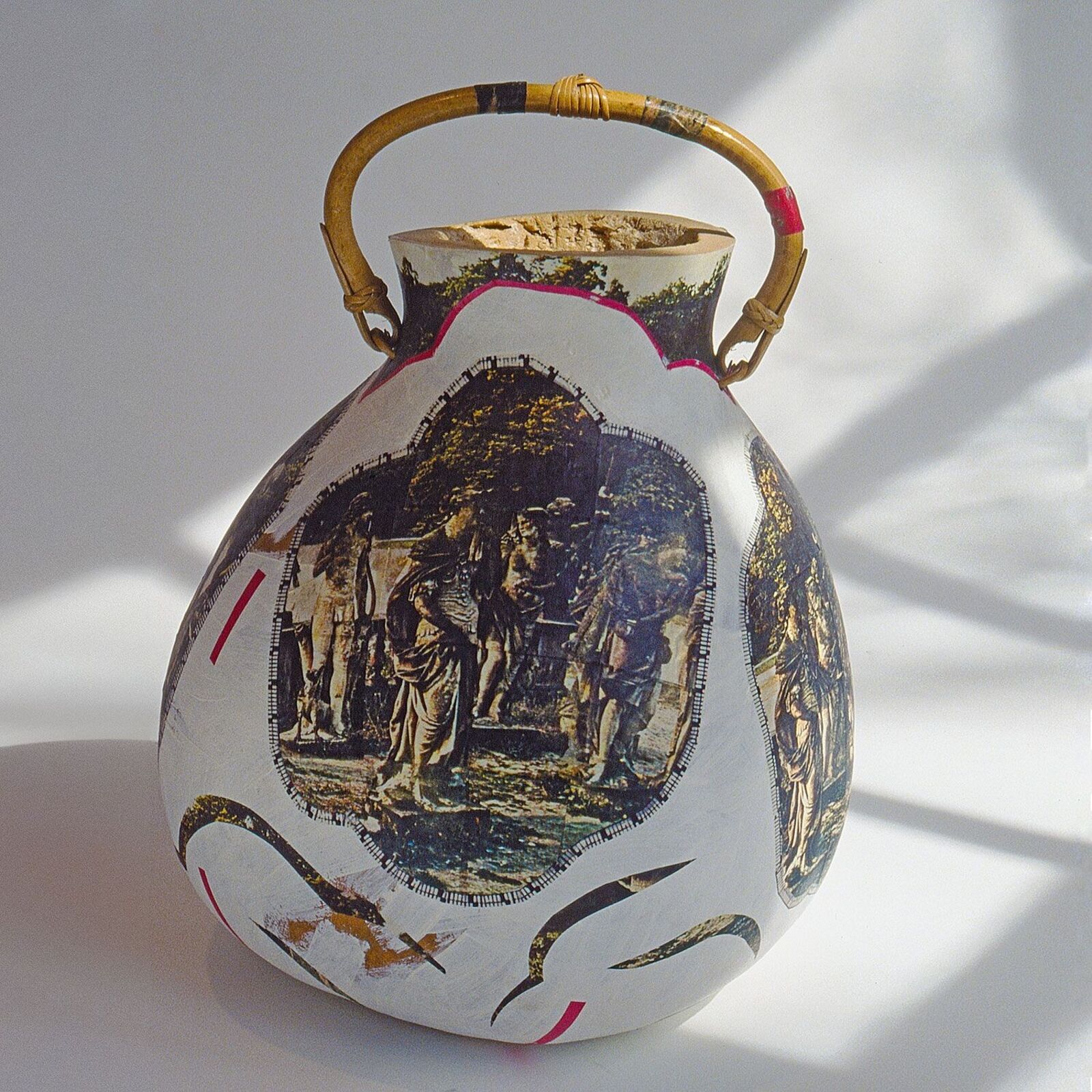 A vase with a picture of a group of people on it.