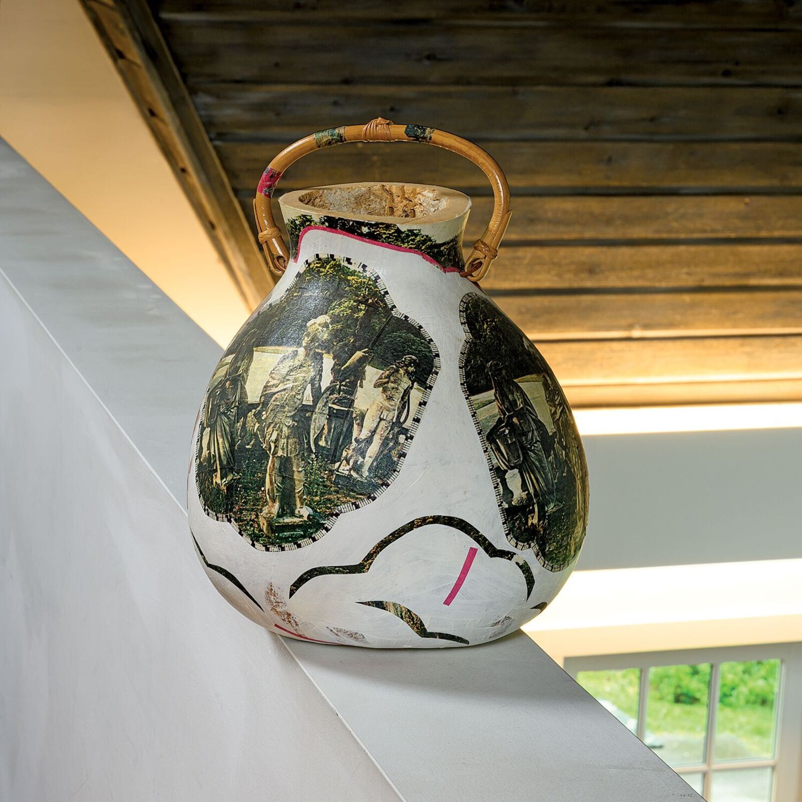 A vase with a picture of a group of people on it.