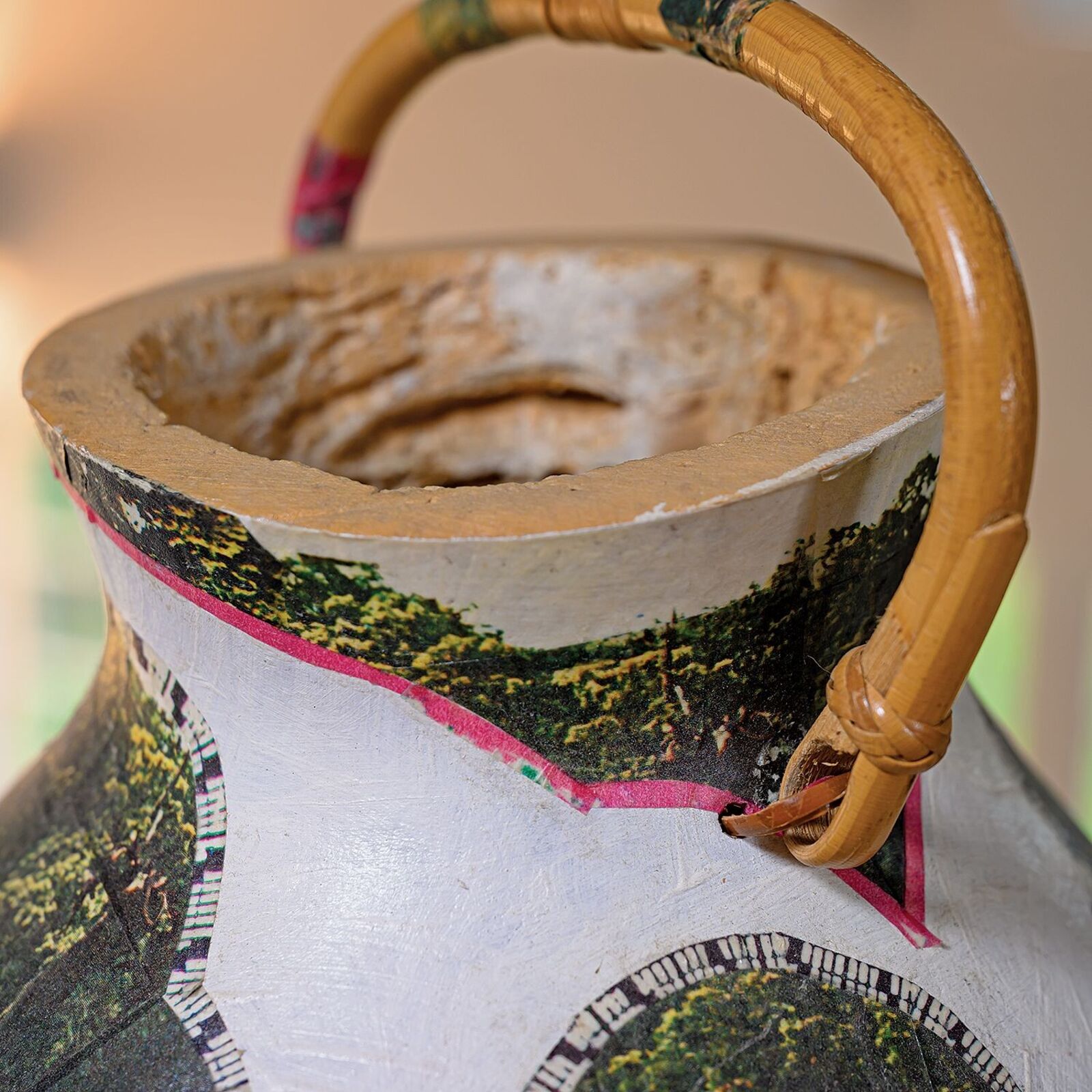 A vase with a picture of a group of people on it.