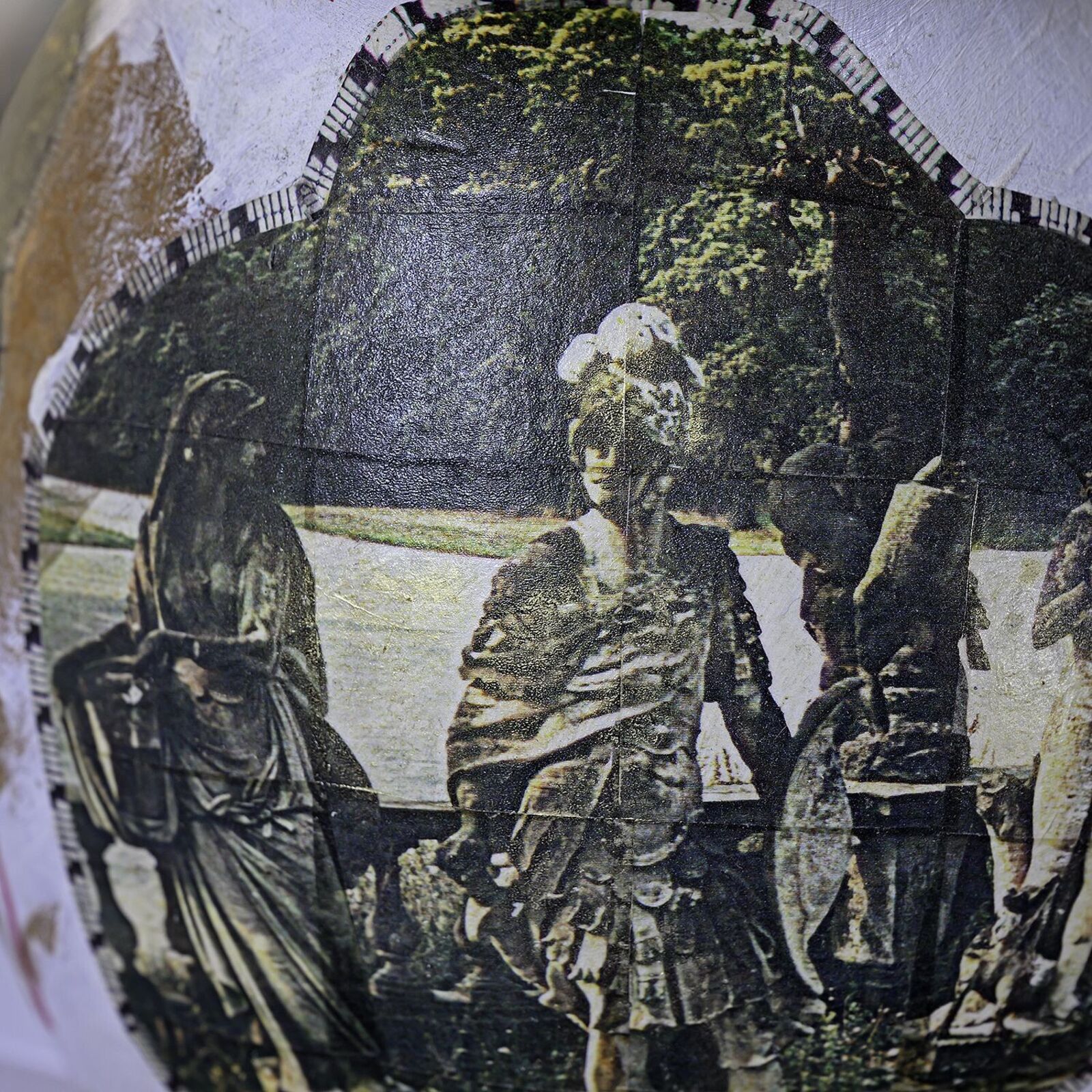 A vase with a picture of a group of people on it.