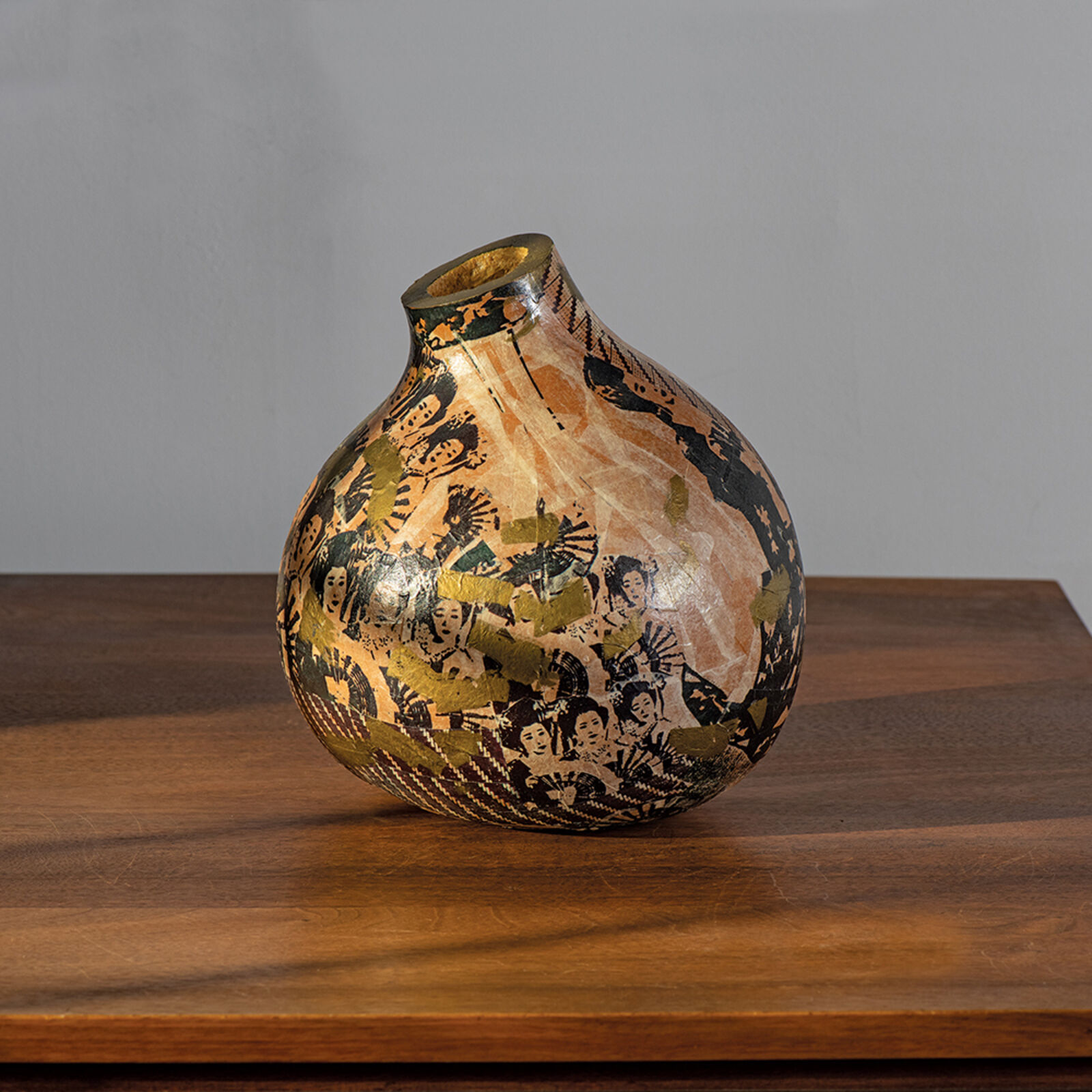A vase sitting on top of a wooden table.