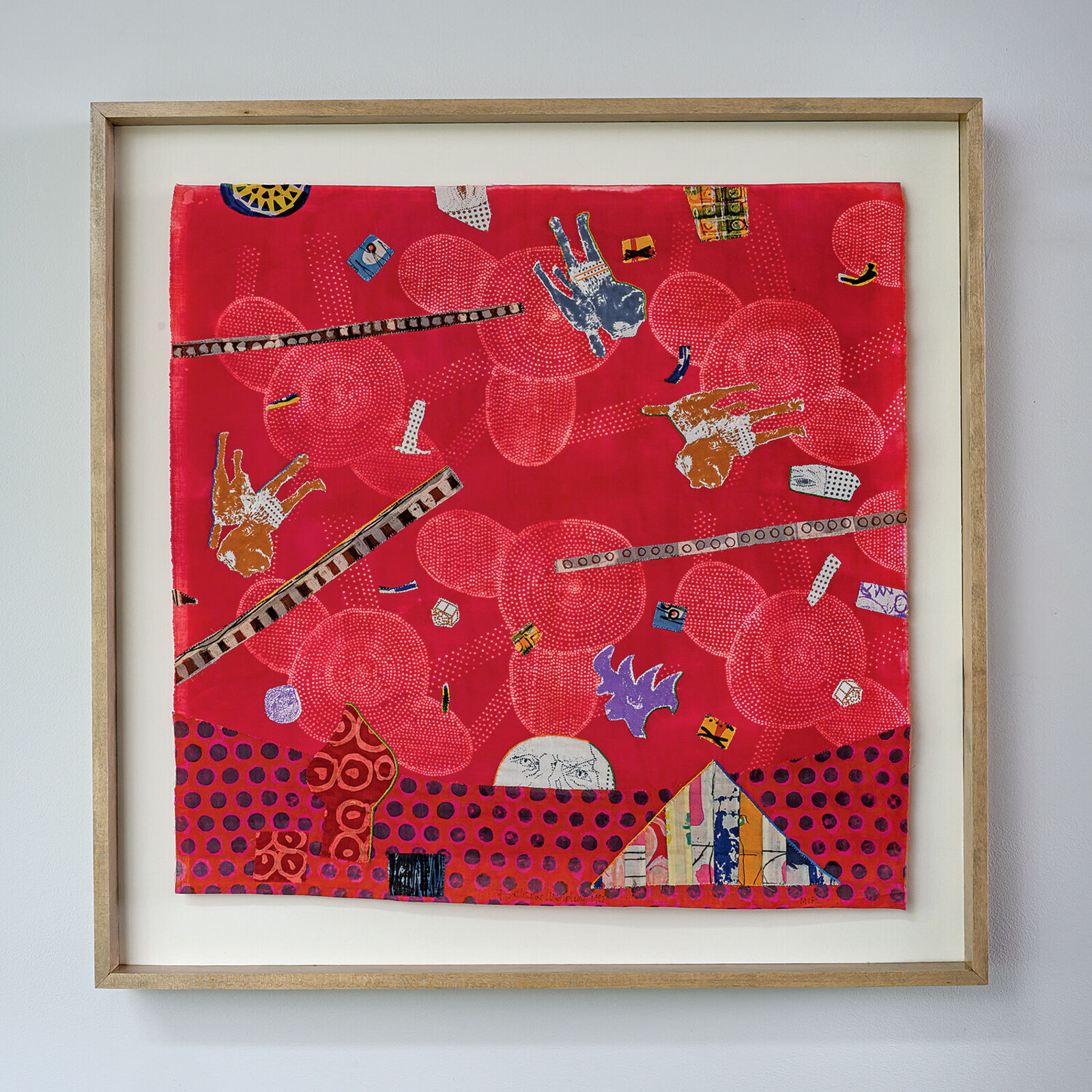 A picture of a red wall hanging on a white wall.