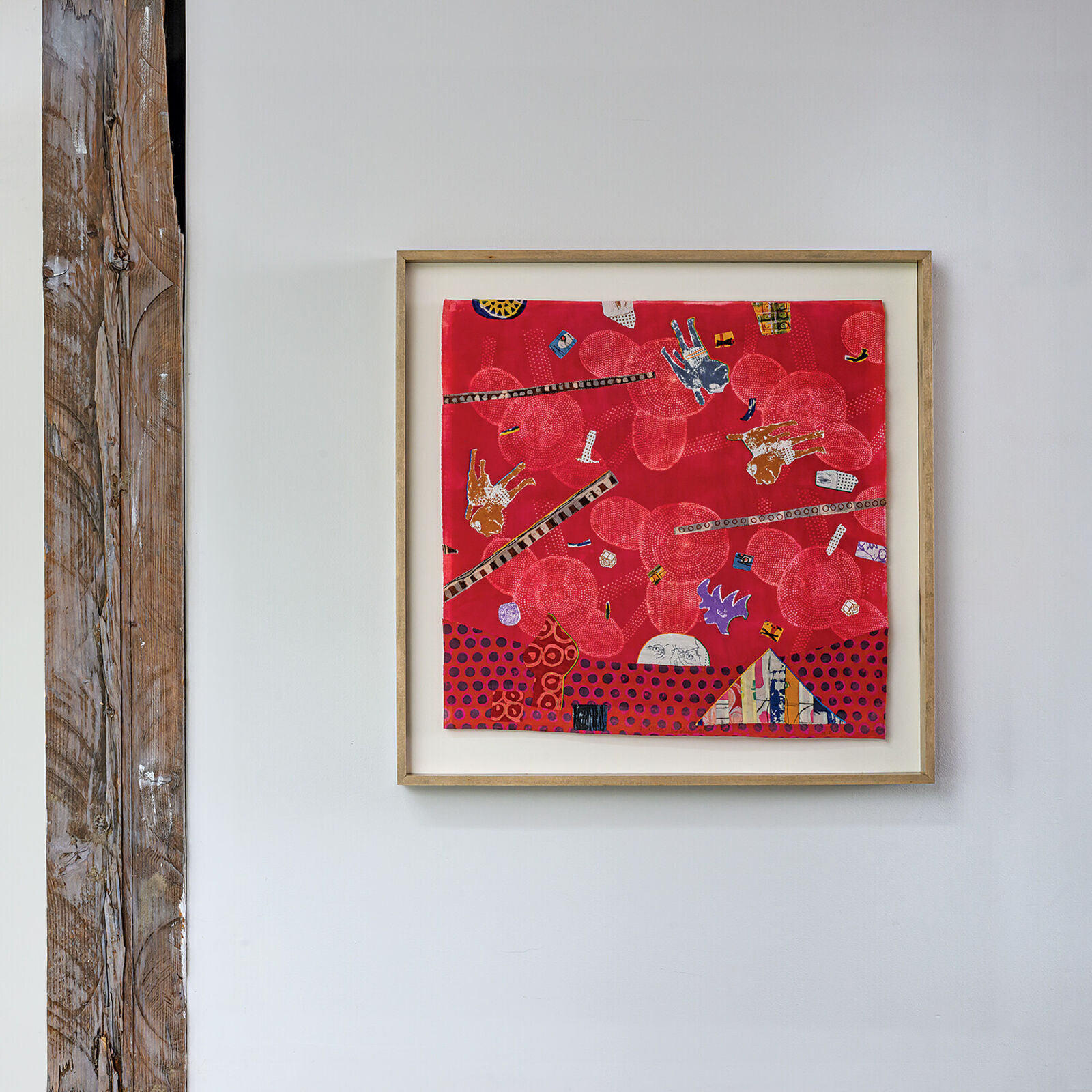 A picture of a red wall hanging on a white wall.