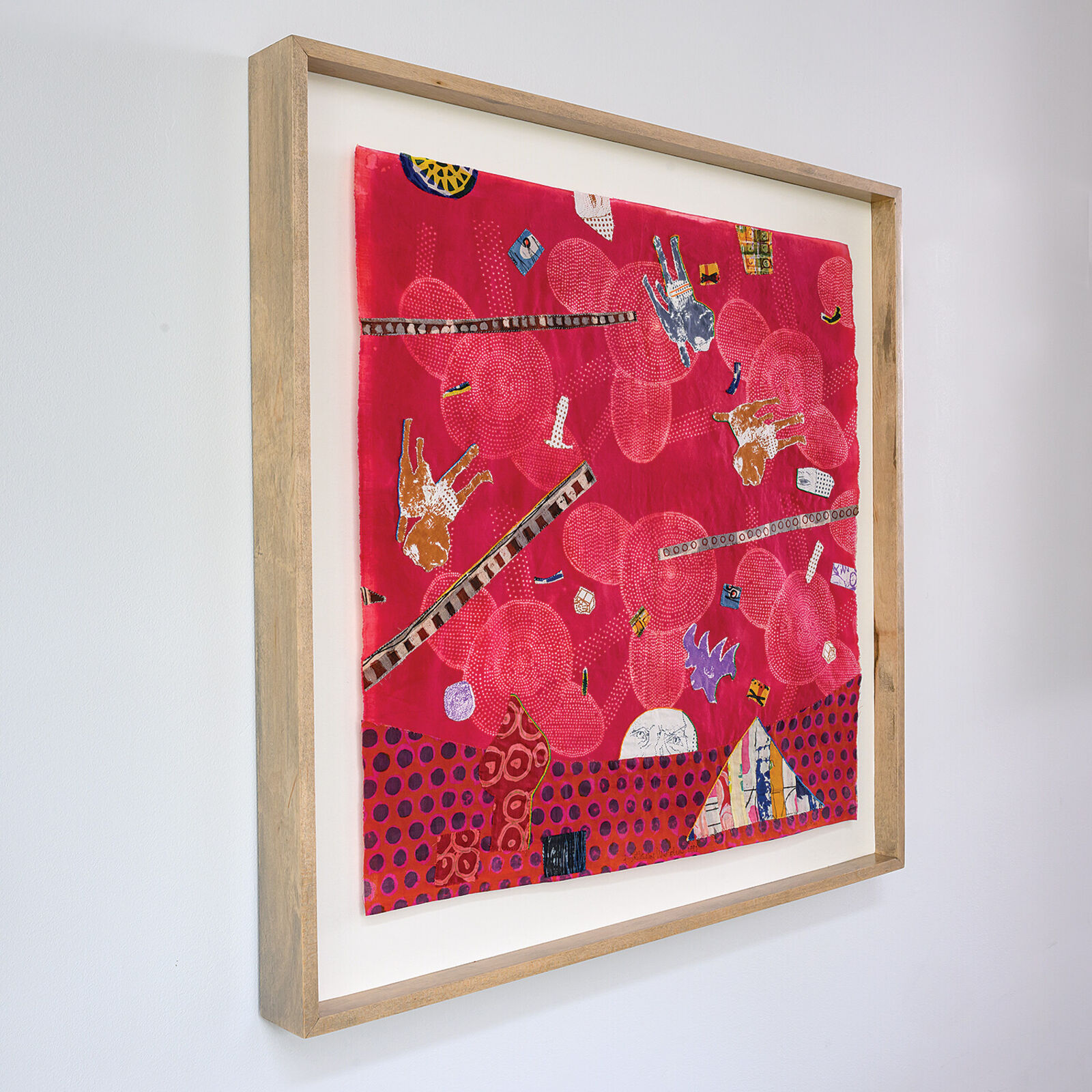 A picture of a red wall hanging on a white wall.
