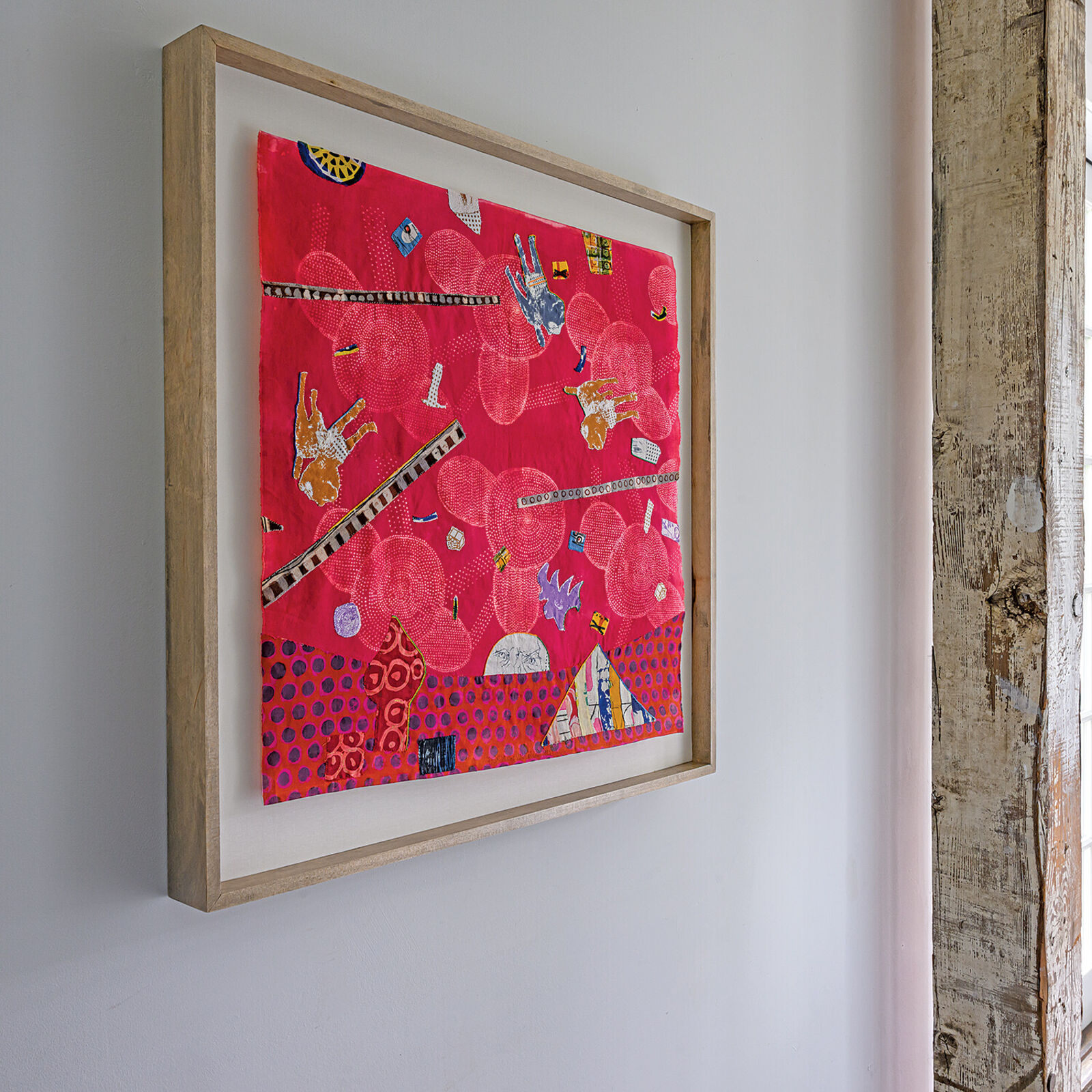A picture of a red wall hanging on a white wall.