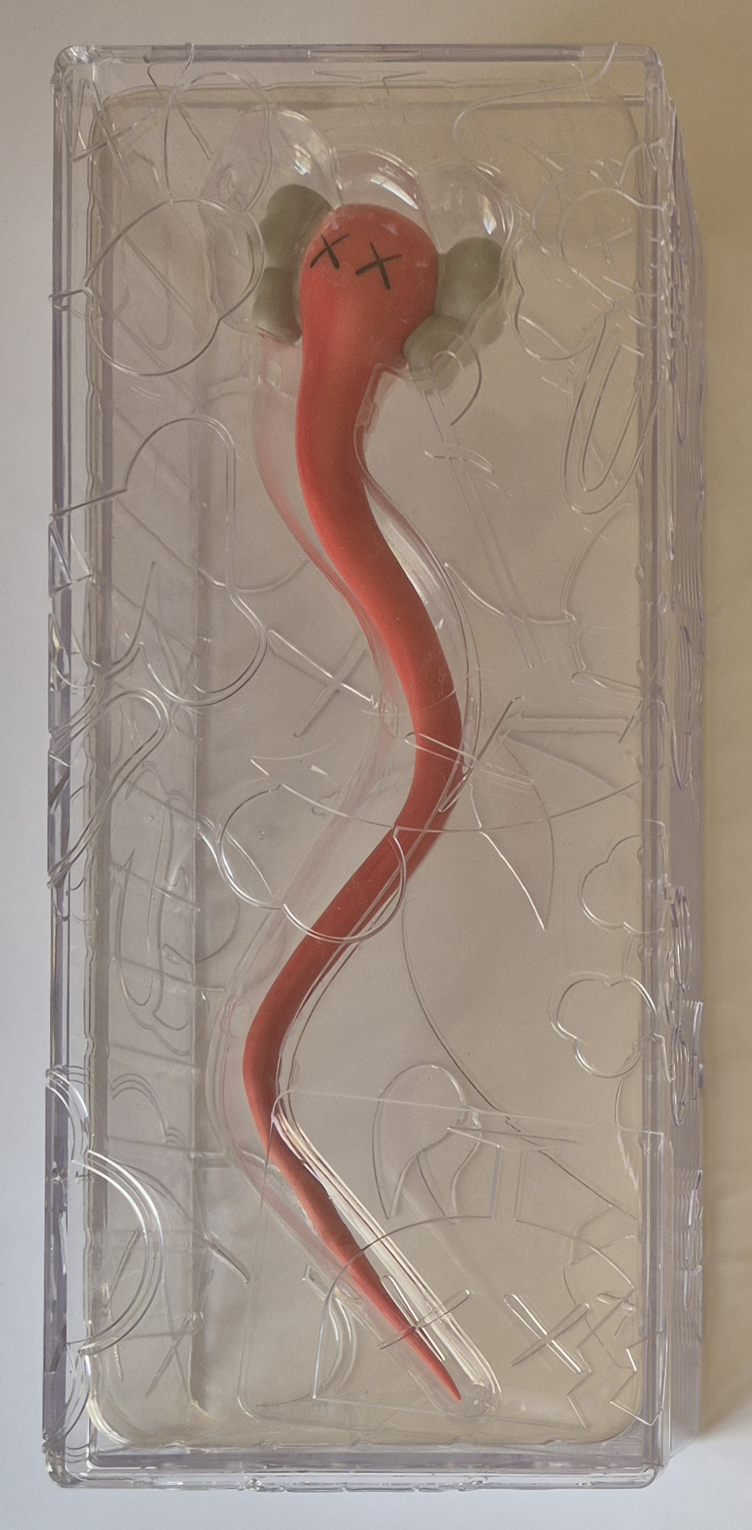 A pair of red and gray earbuds in a clear plastic case.