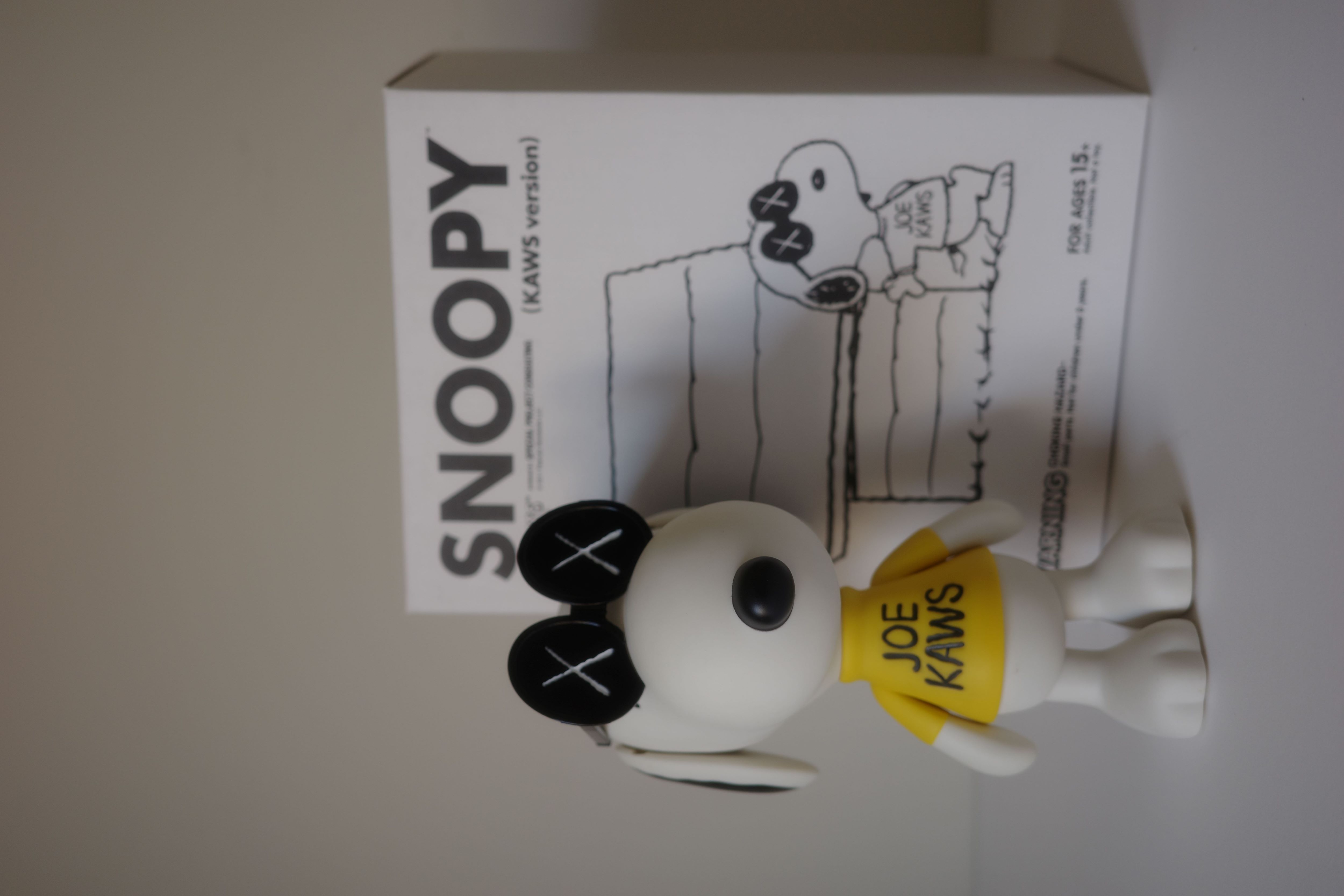 A stylized white dog figure wearing oversized sunglasses and a yellow shirt with black text.