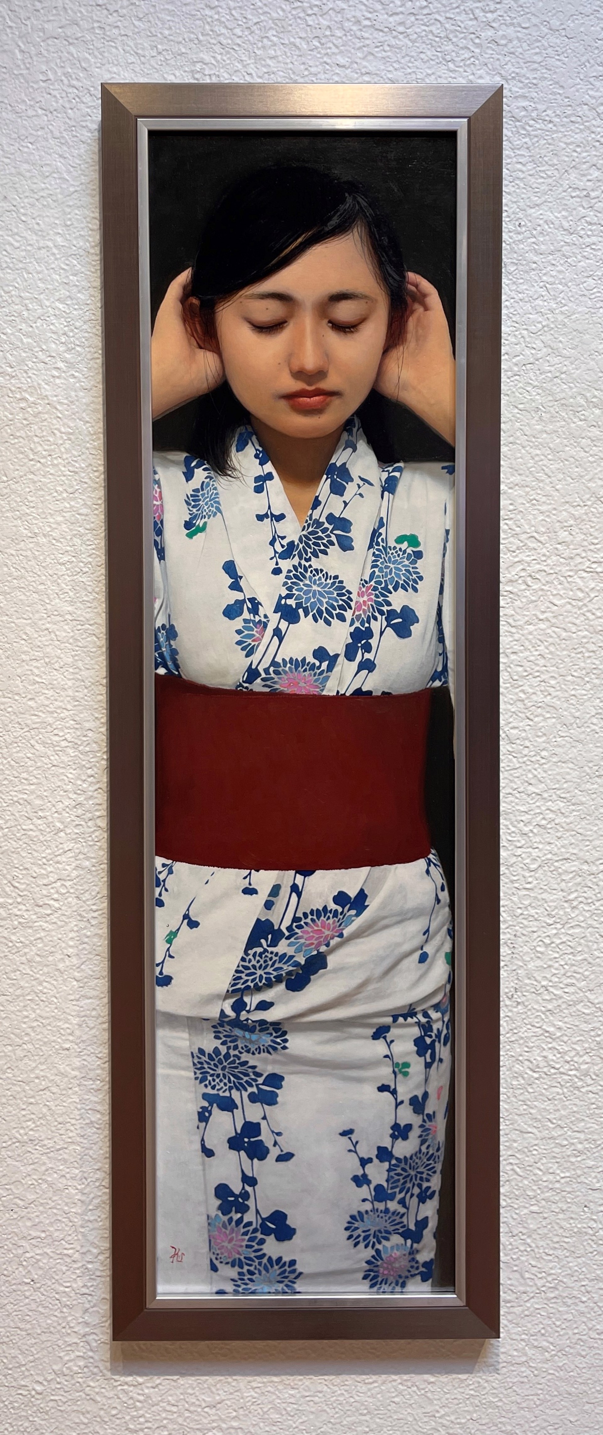 A portrait of a figure in a floral kimono with hands raised to the head.
