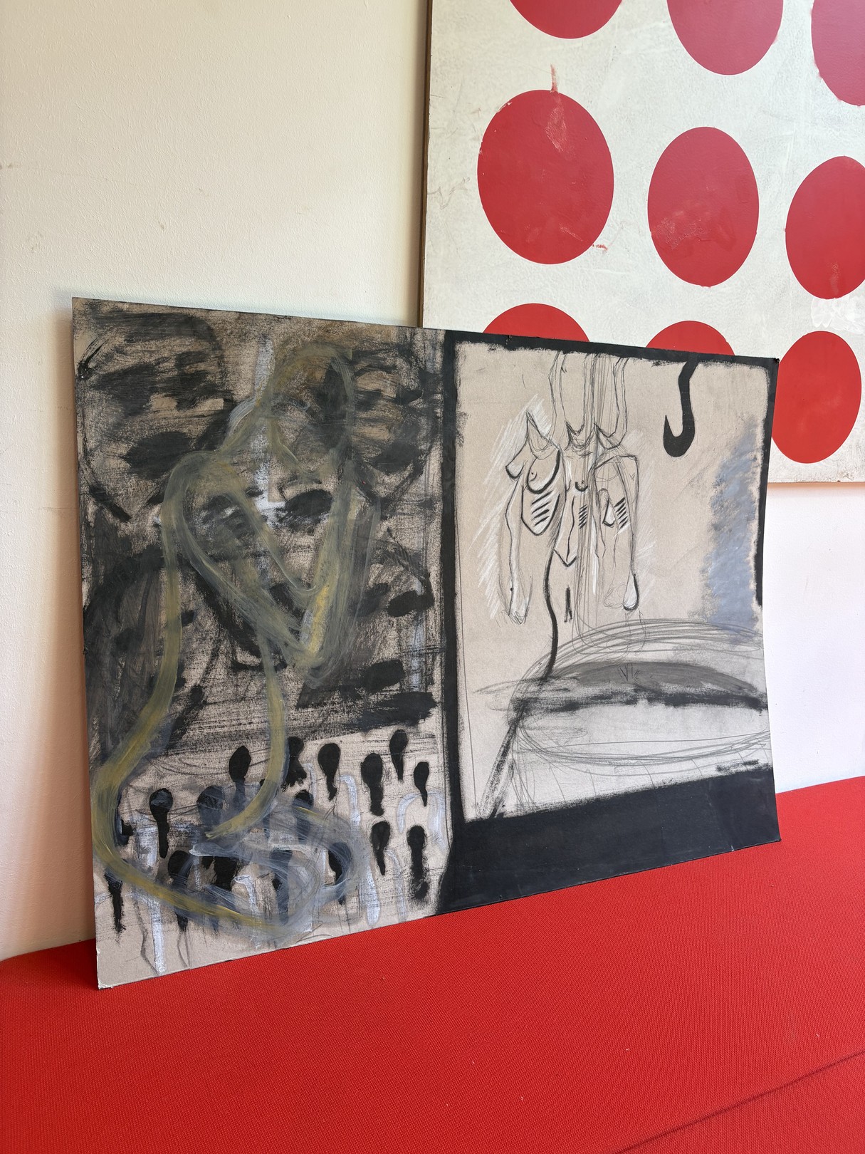 A split-panel artwork featuring abstract figures against a red polka-dot backdrop.
