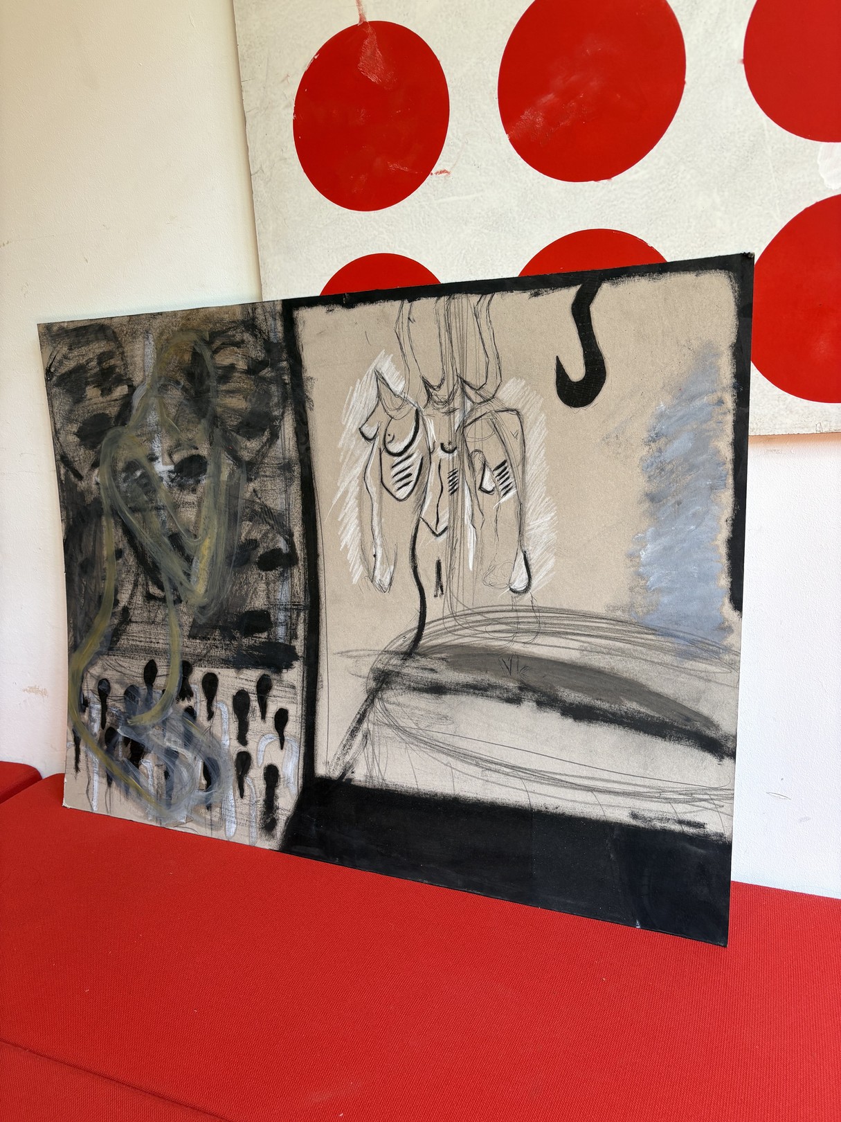 A split-panel artwork featuring abstract figures against a red polka-dot backdrop.