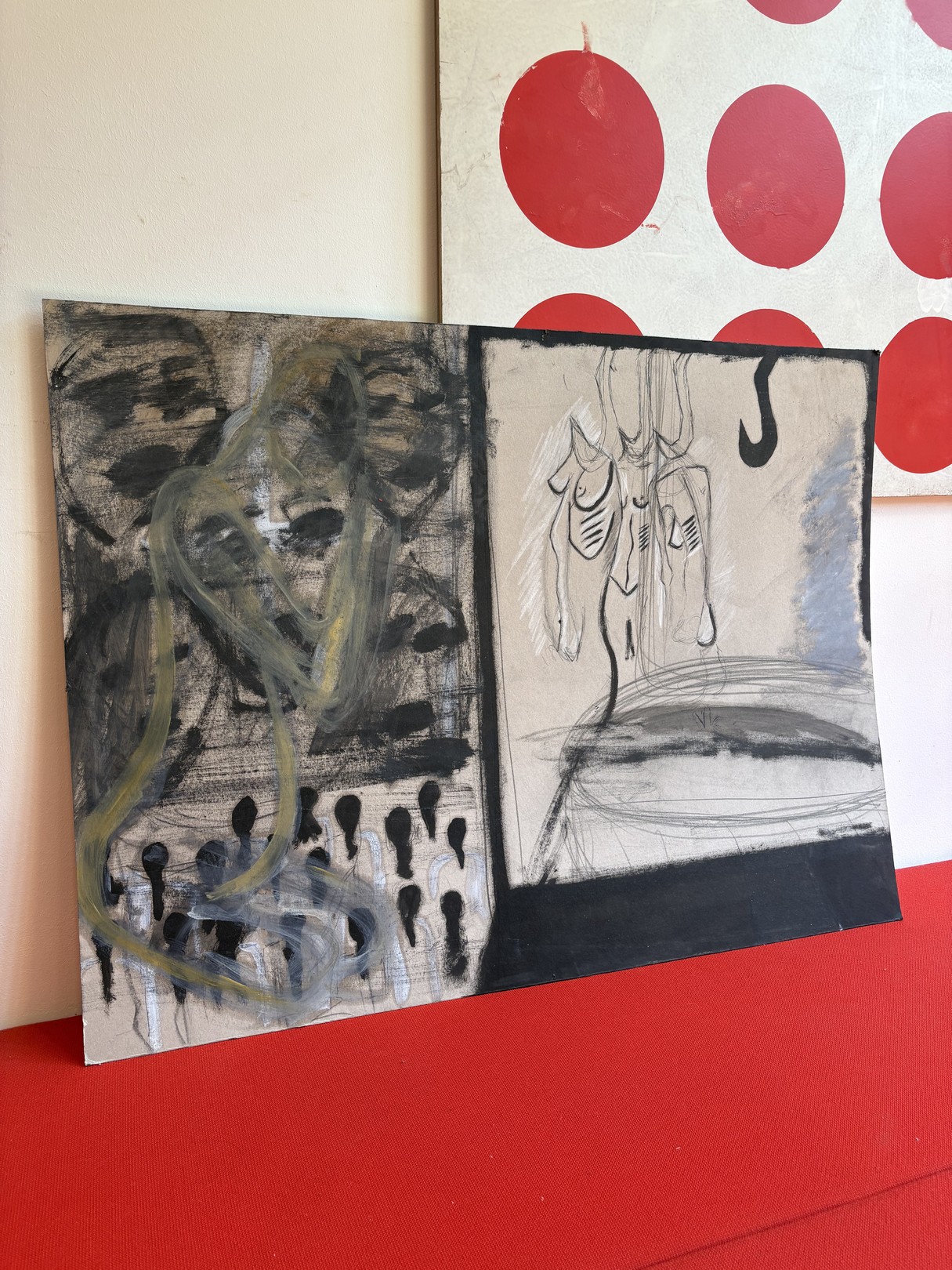 A split-panel artwork featuring abstract figures against a red polka-dot backdrop.
