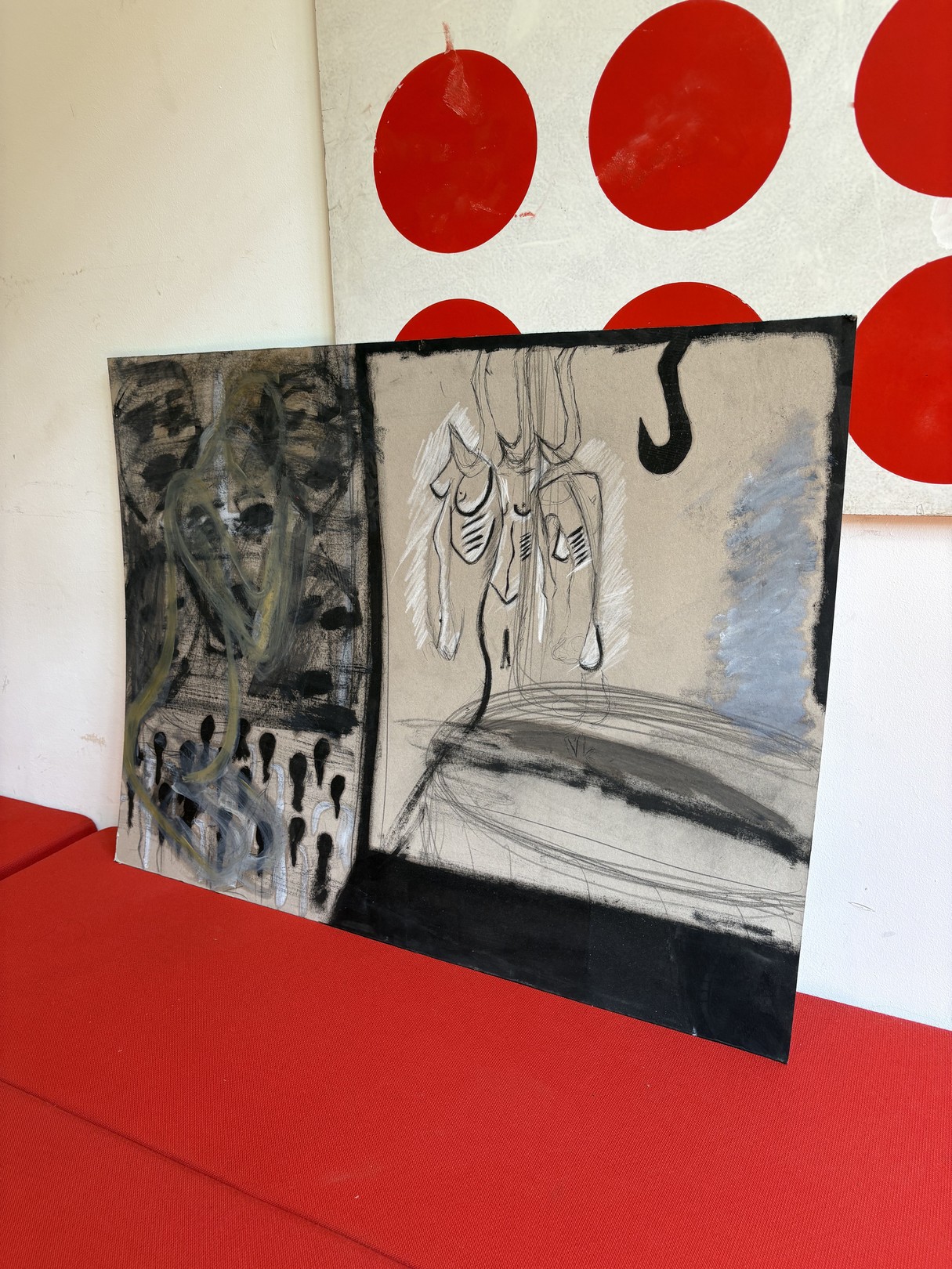 A split-panel artwork featuring abstract figures against a red polka-dot backdrop.