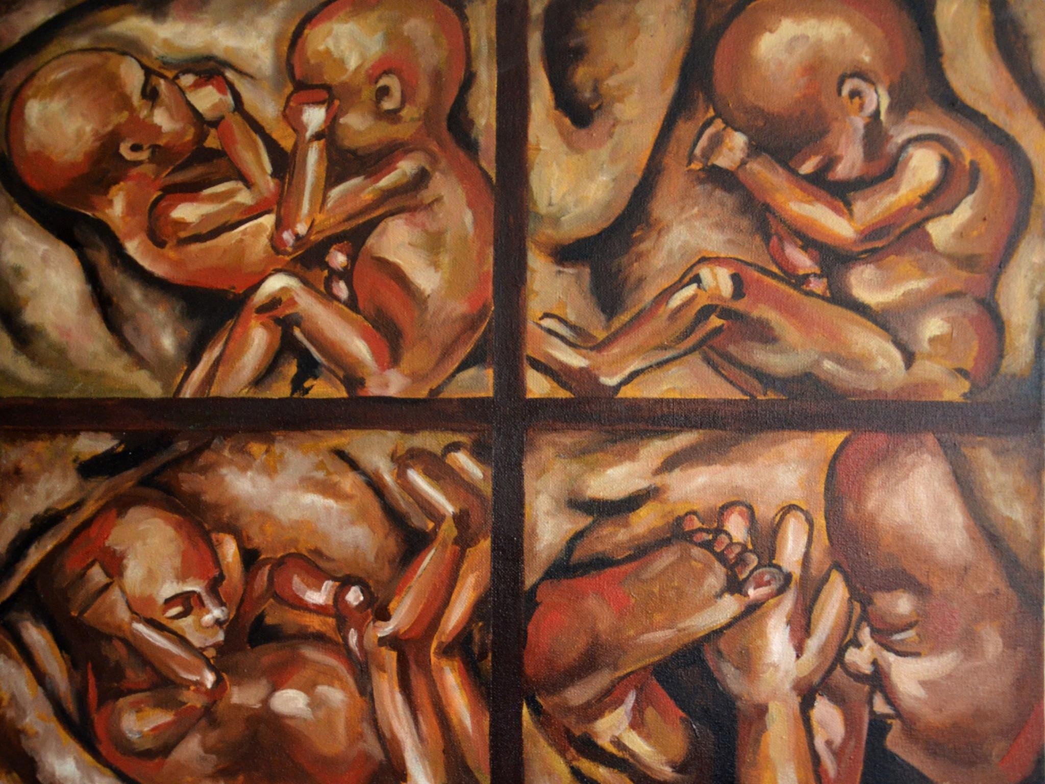 A painting of four pictures of a baby in a womb.