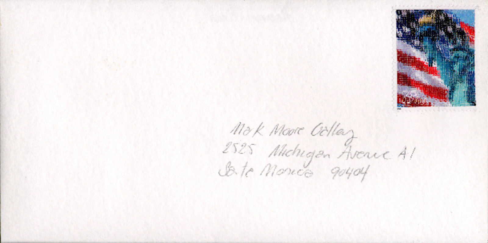 A white envelope with a colorful postage stamp and handwritten address.