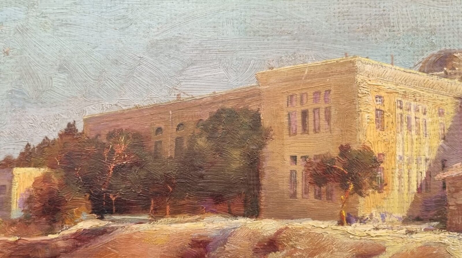 A sun-drenched street scene with figures resting near a large building.