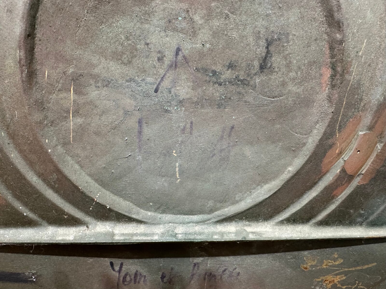 A square relief sculpture featuring a central sphere and geometric triangles with a dark, patinated metal surface.