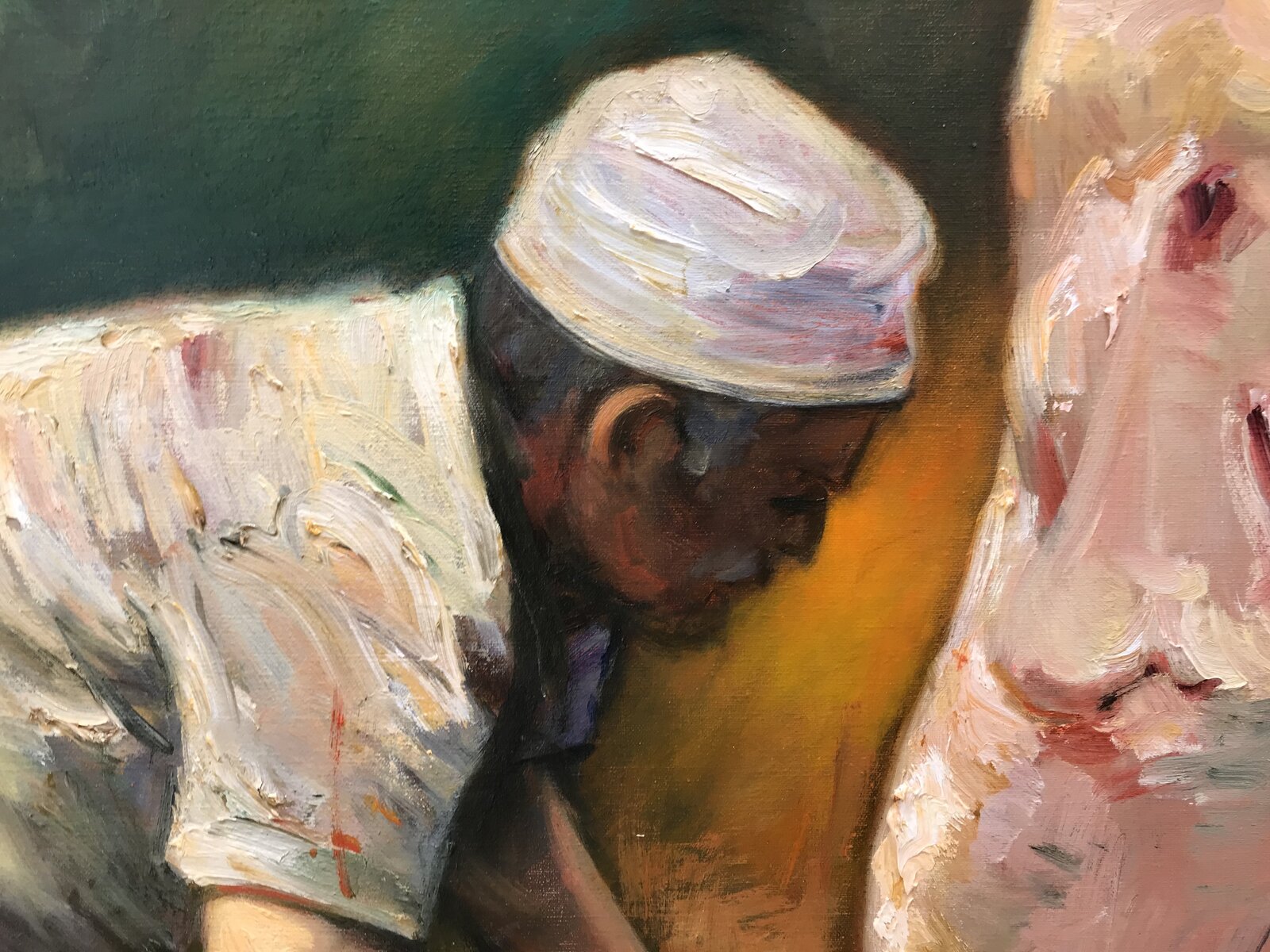 A butcher in a white cap works at a hanging carcass in a dimly lit, warm-toned workshop.