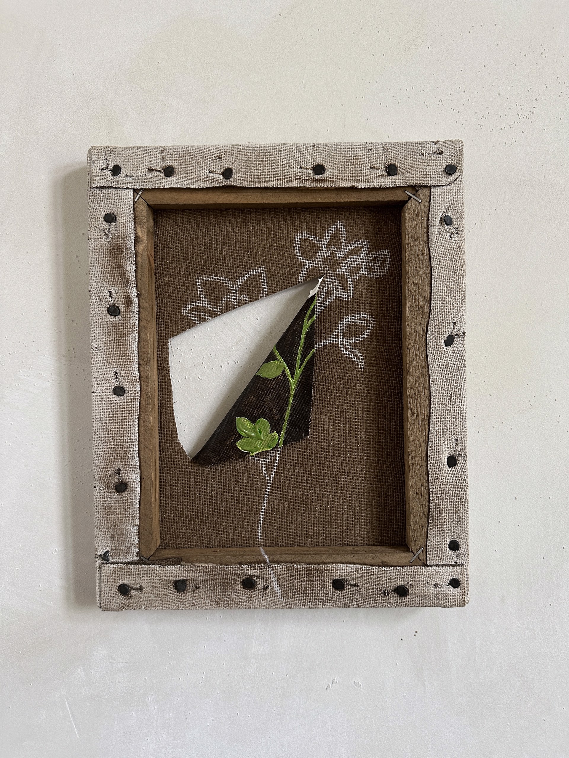 A picture of a paper airplane with a flower in it.