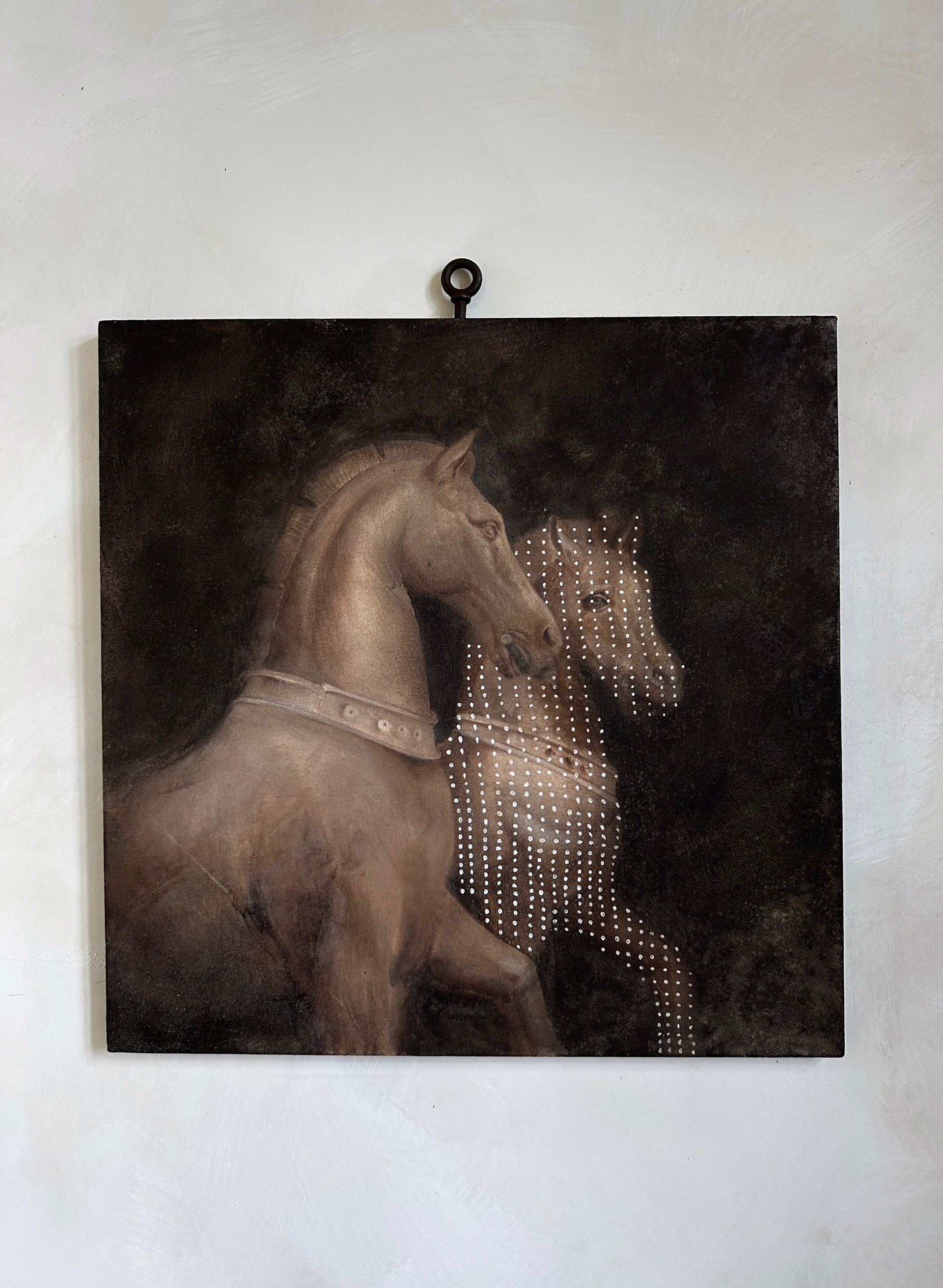 A surreal composition featuring a solid horse and a dotted, ghostly horse.