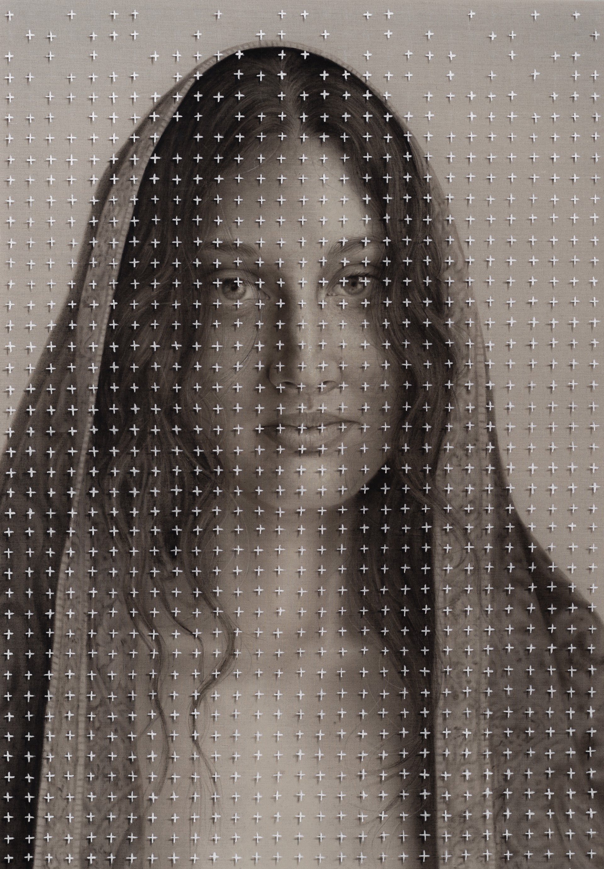 A picture of a woman with long hair on a wall.