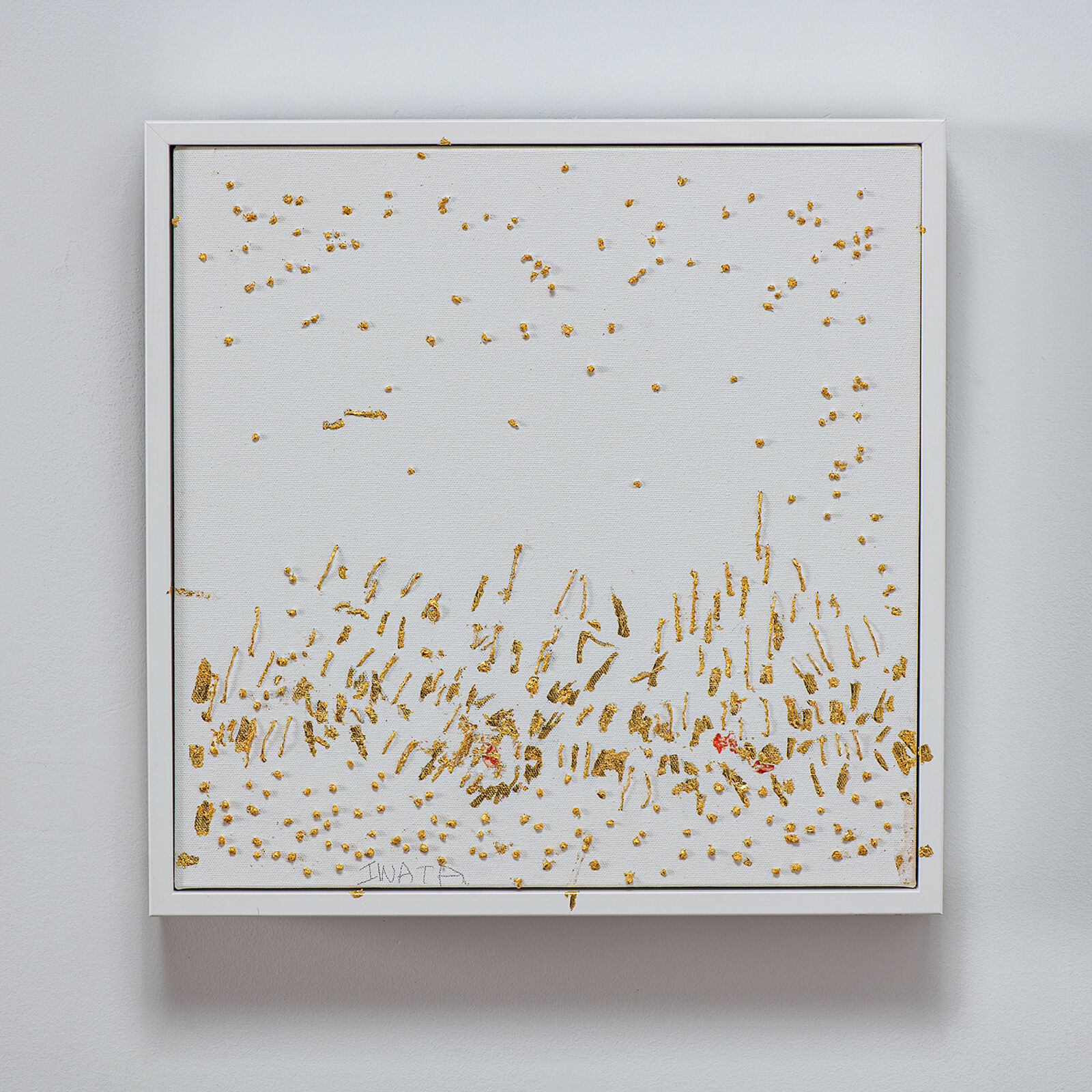 A textured canvas artwork featuring scattered gold leaf fragments and a dense cluster of vertical strokes at the bottom.