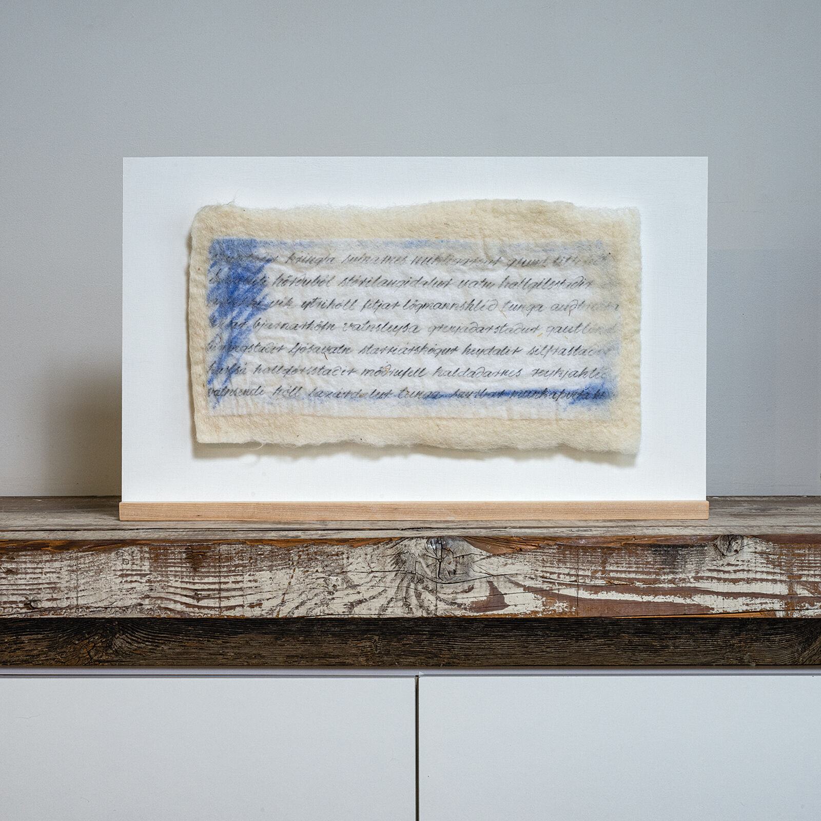 A piece of paper with writing on it sitting on a shelf.
