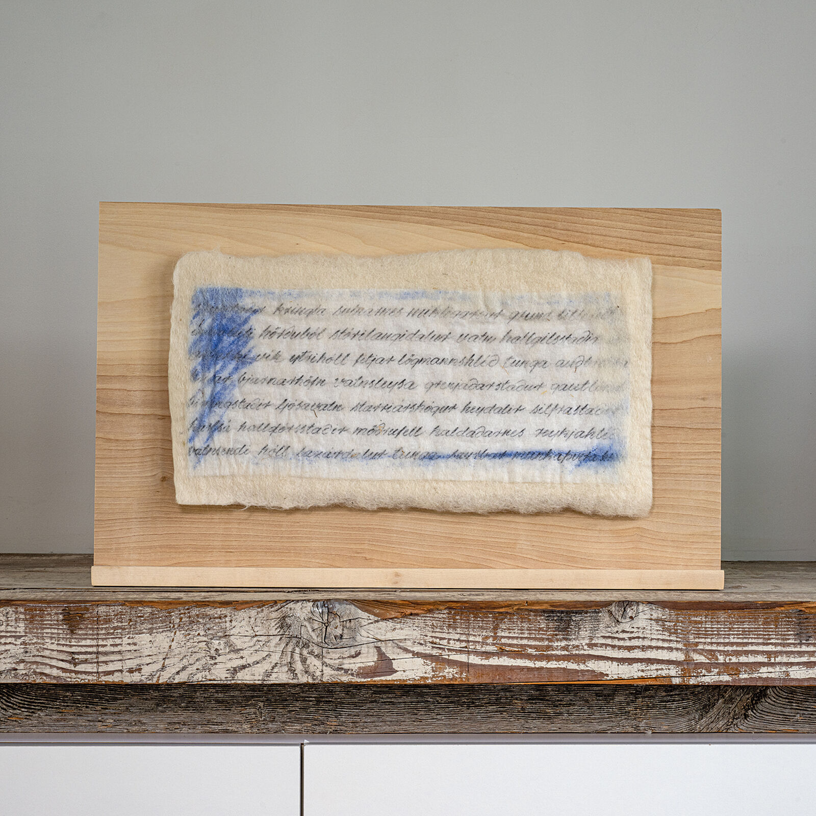 A piece of paper with writing on it sitting on a shelf.