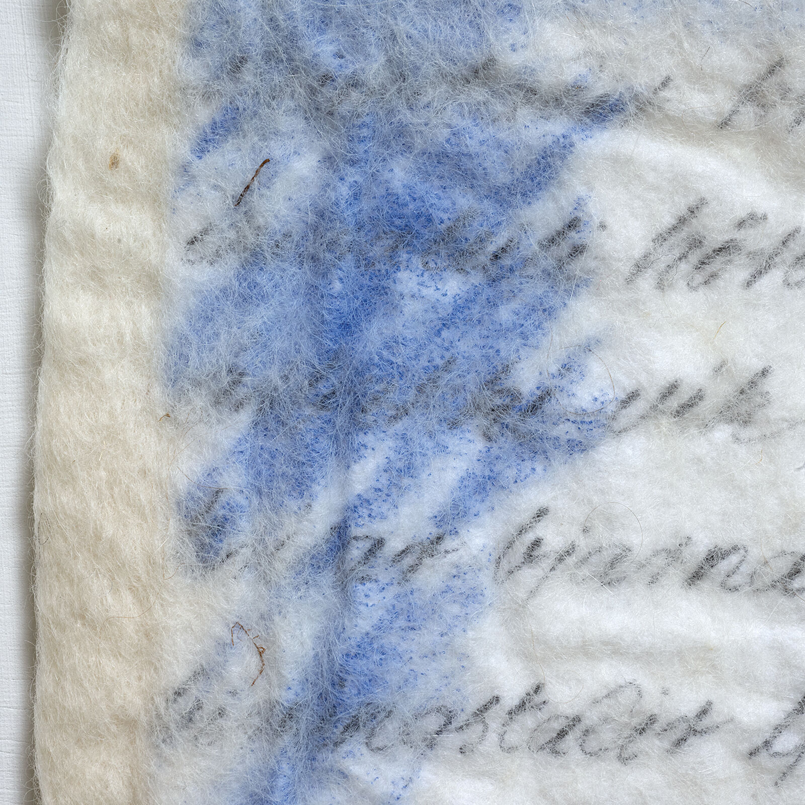 A piece of paper with writing on it sitting on a shelf.