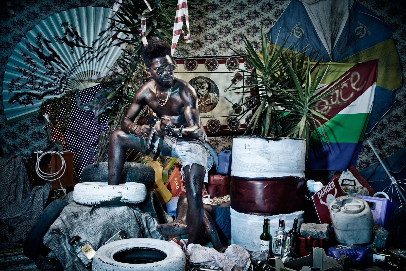 A man sitting on top of a pile of trash.