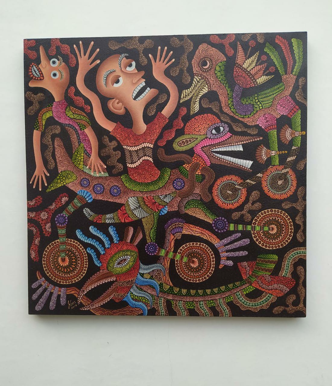 A vibrant, dot-painted artwork featuring a central figure surrounded by mythical creatures and abstract symbols.