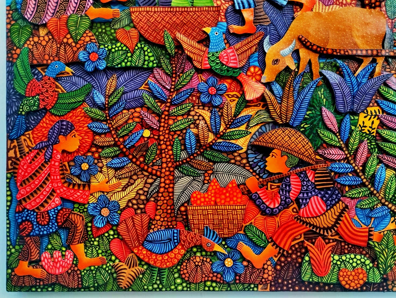 A vibrant, textured tapestry depicting a lush, stylized forest scene filled with figures and animals.