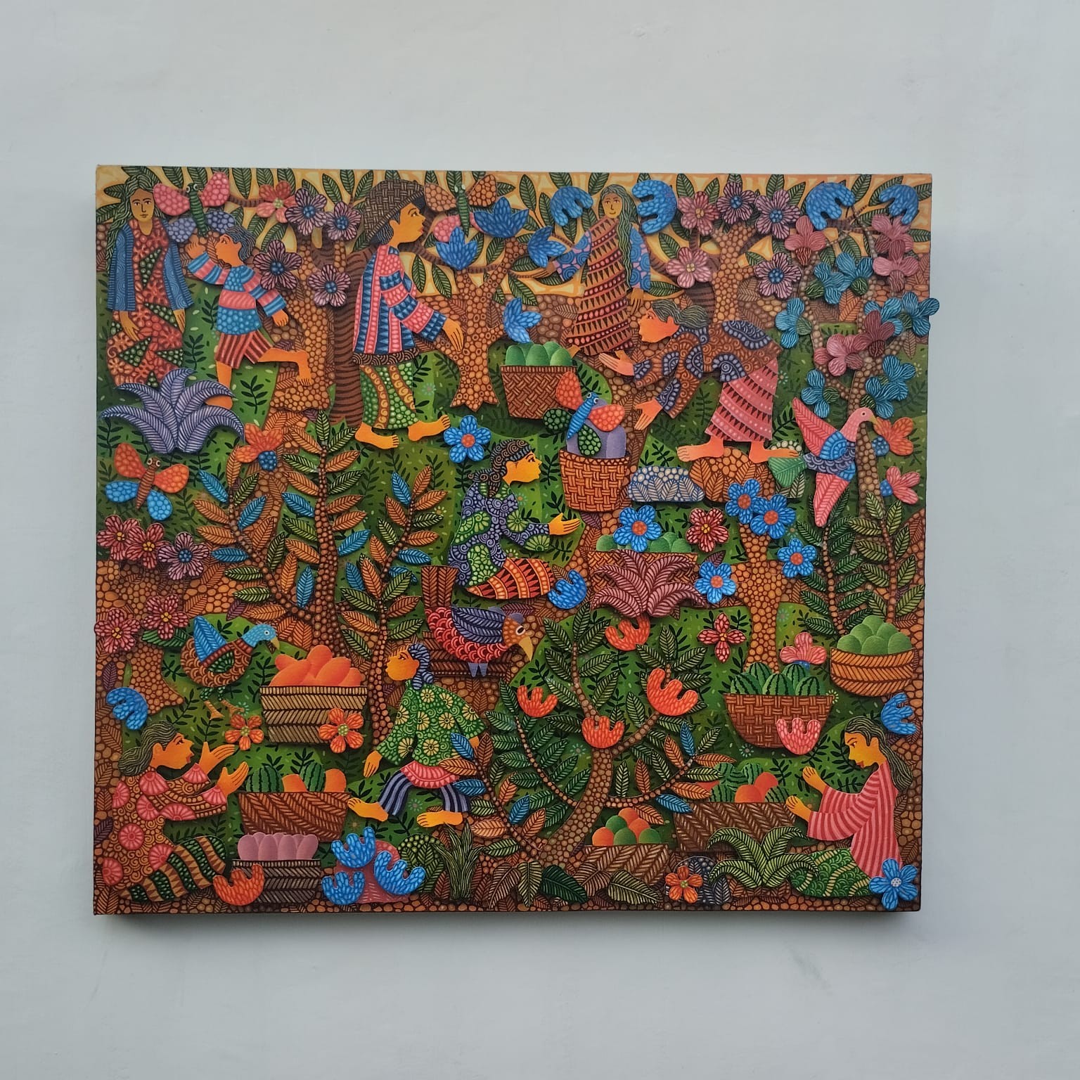A colorful painting on a wall in a room.