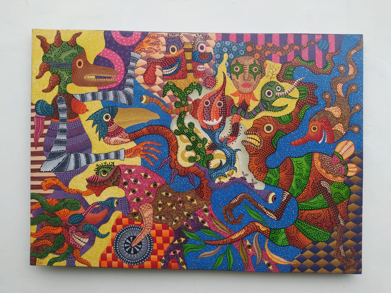 A colorful painting on a white wall in a room.