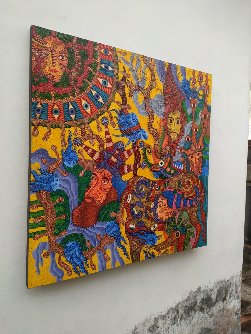 A vibrant, chaotic tapestry of faces and eyes swirling in a dense, colorful composition.