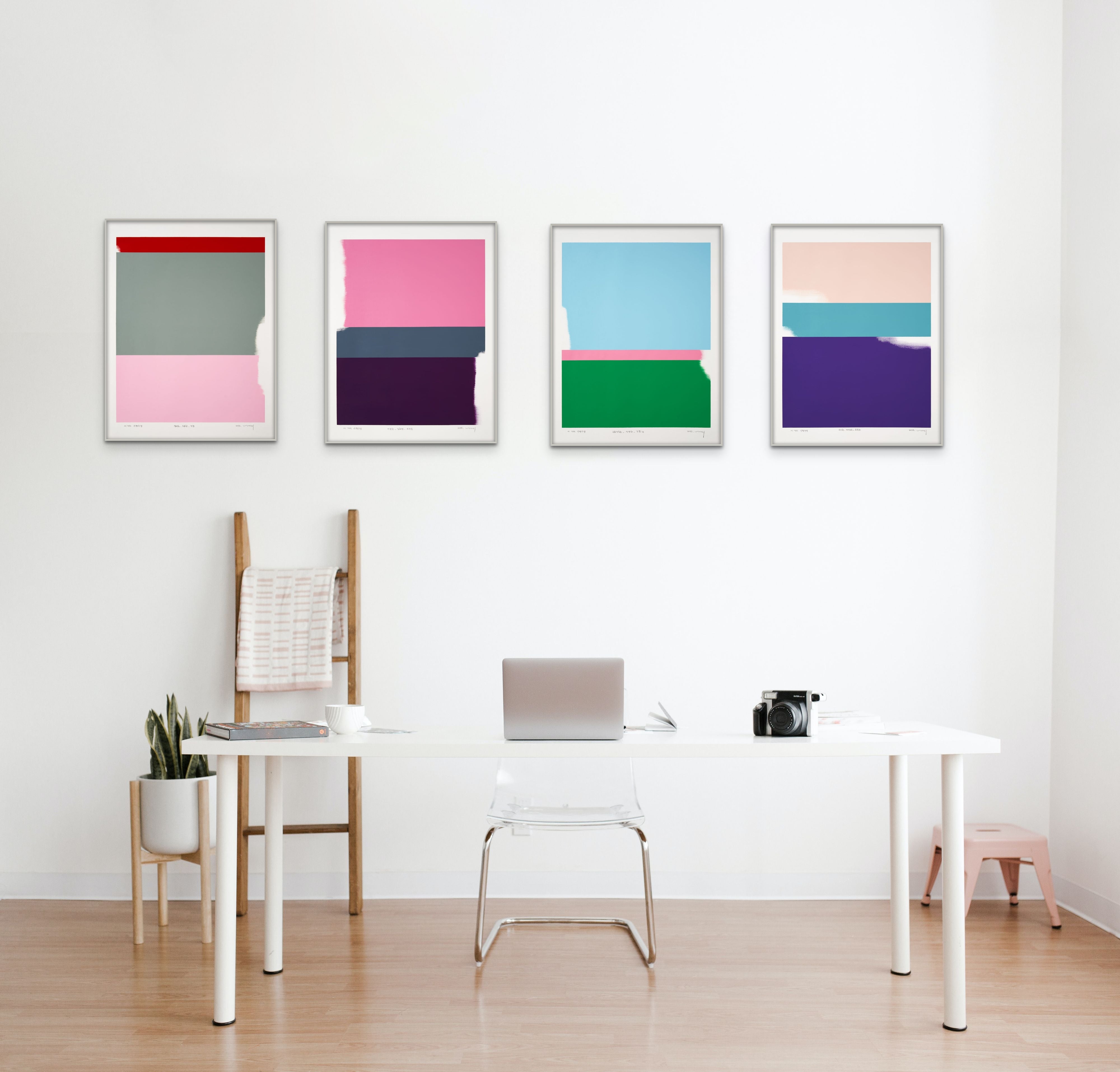 A pink and purple painting on a white wall.