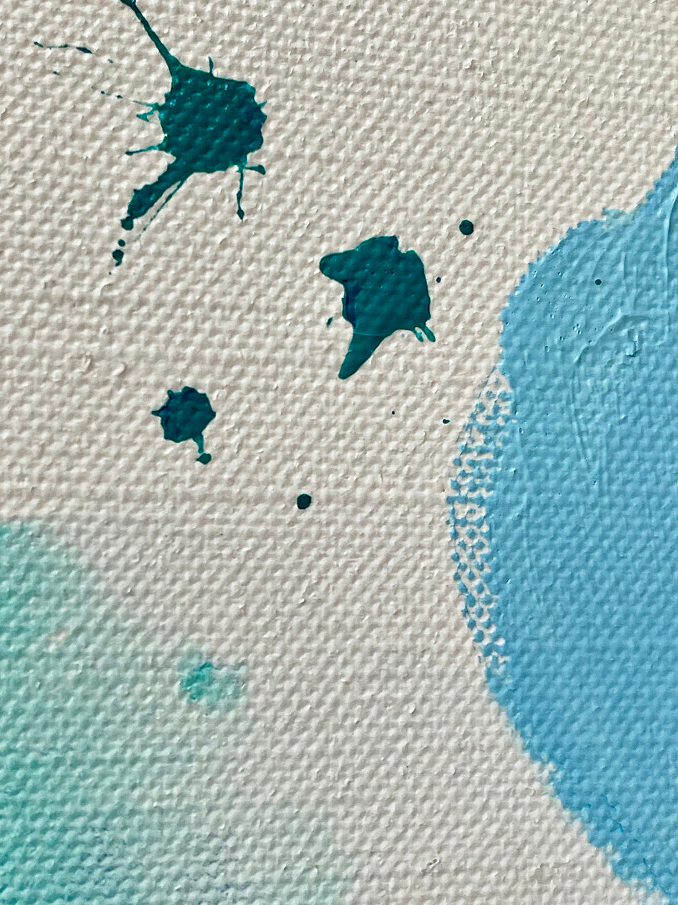 A painting of blue and green paint splatters on a white background.