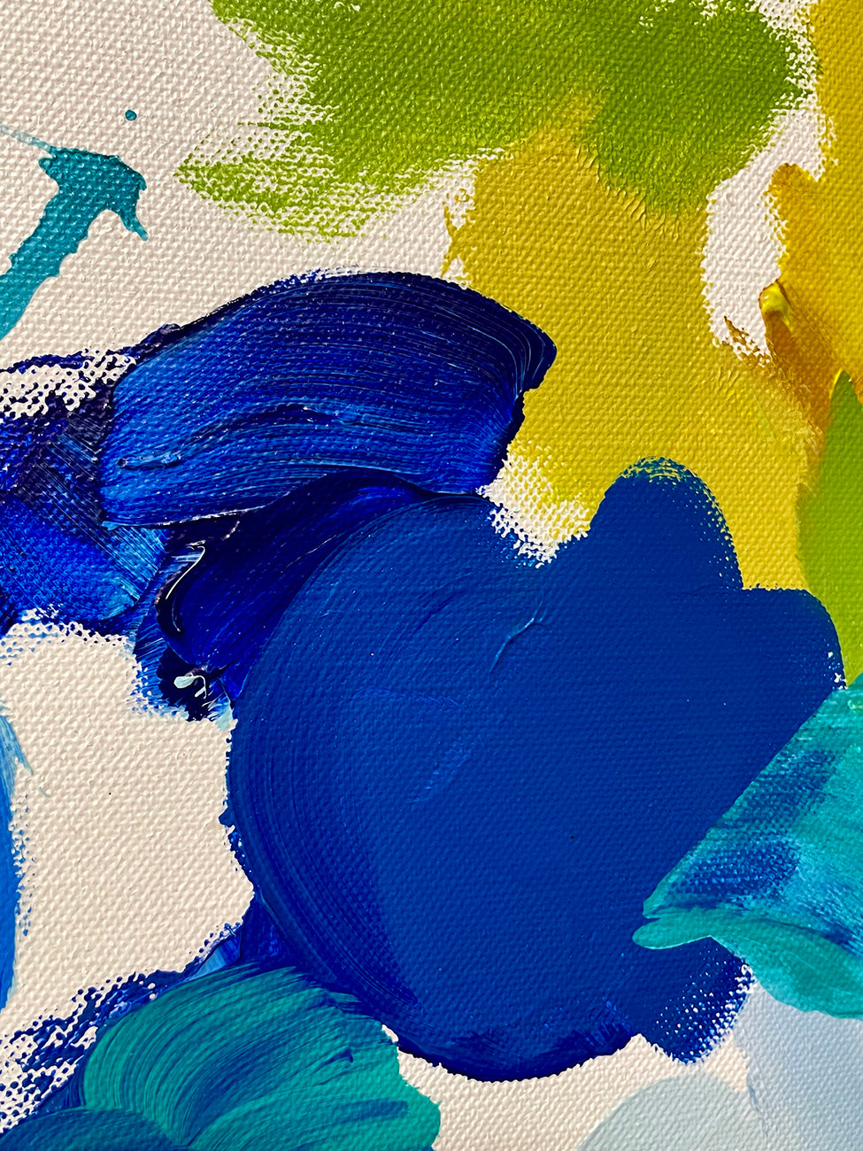 A painting of blue and green paint splatters on a white background.