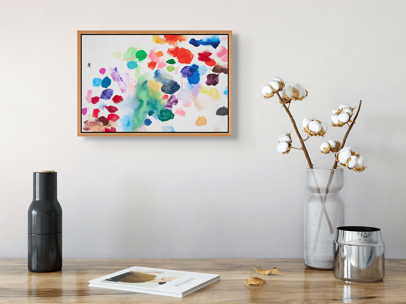 A painting of colorful paint splatters on a white background.