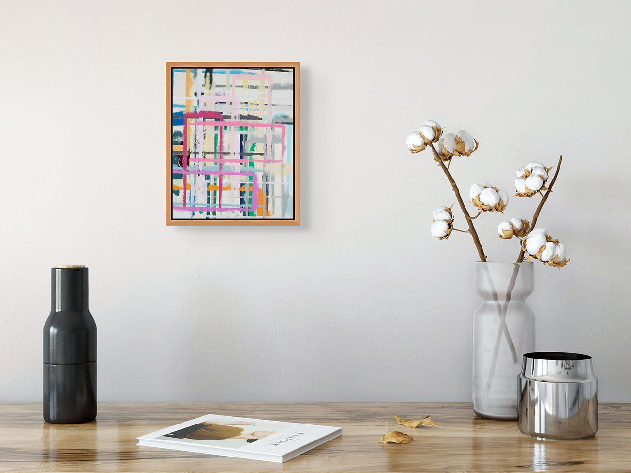 A painting with pink, blue, yellow, and green squares on a white background.